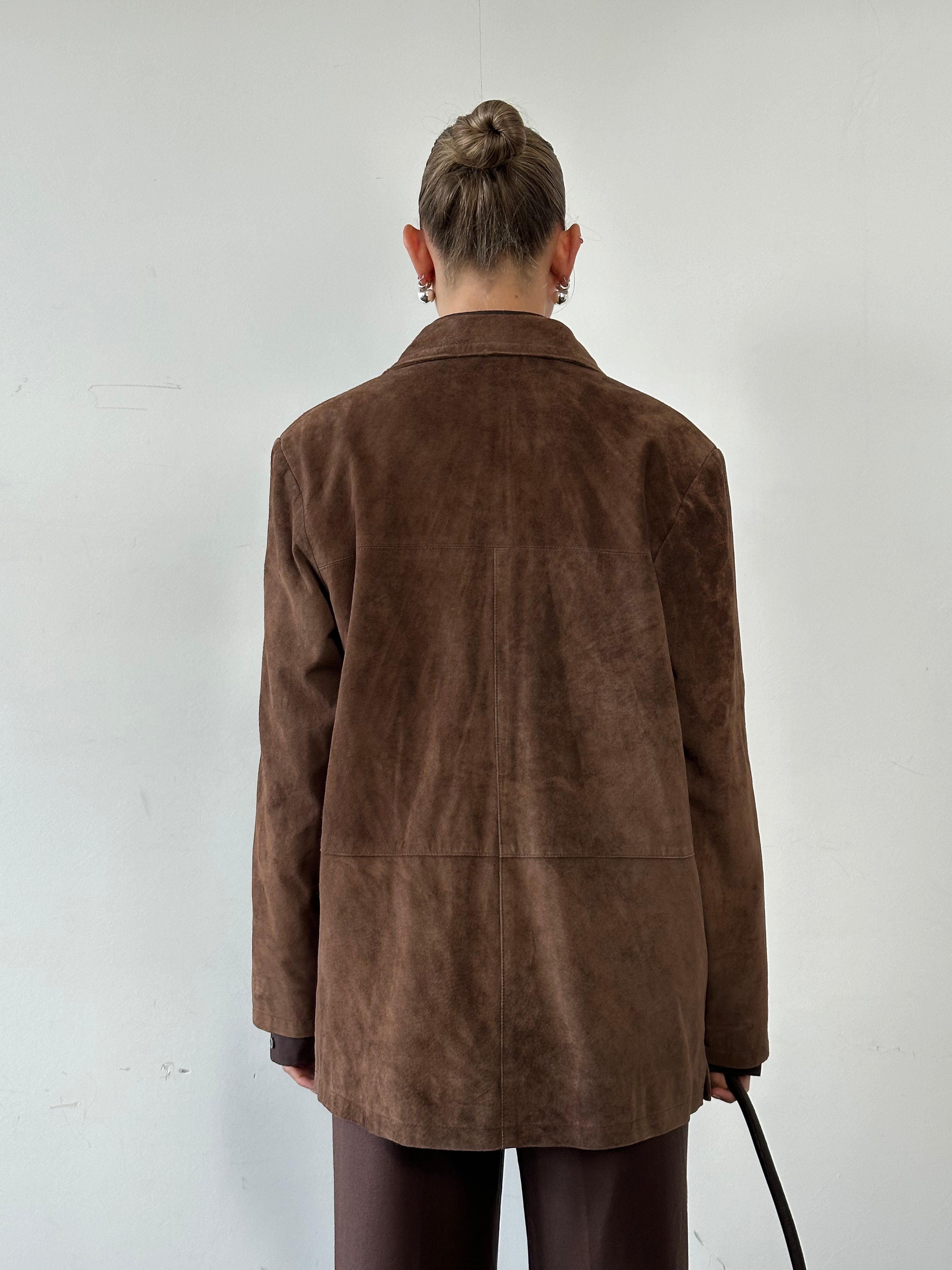 Vintage suede jacket in size large, stylish and classic, with a soft textured appearance and tailored fit.