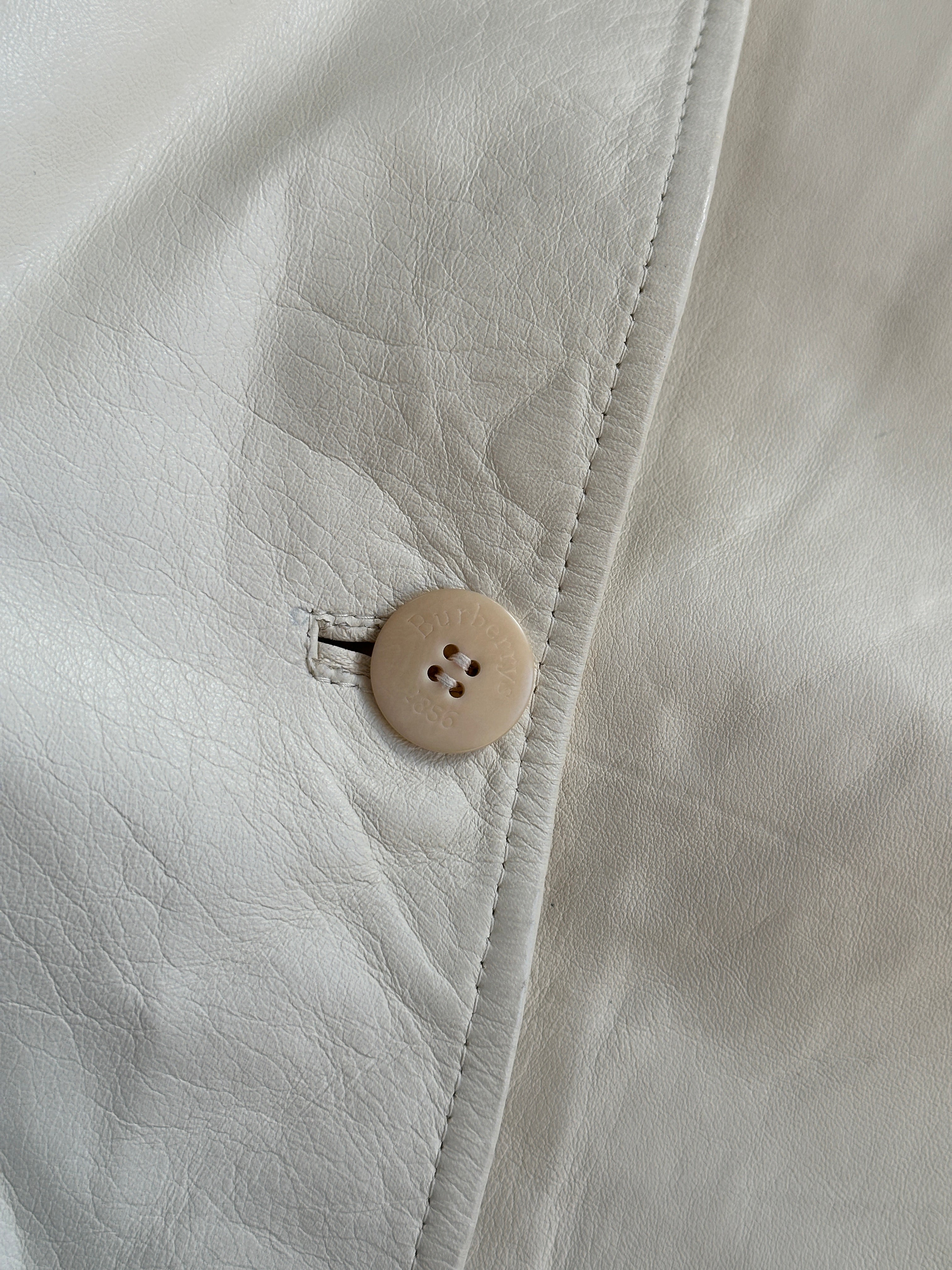 Burberry boxy leather jacket in black with classic design and silver hardware, displayed on a hanger.