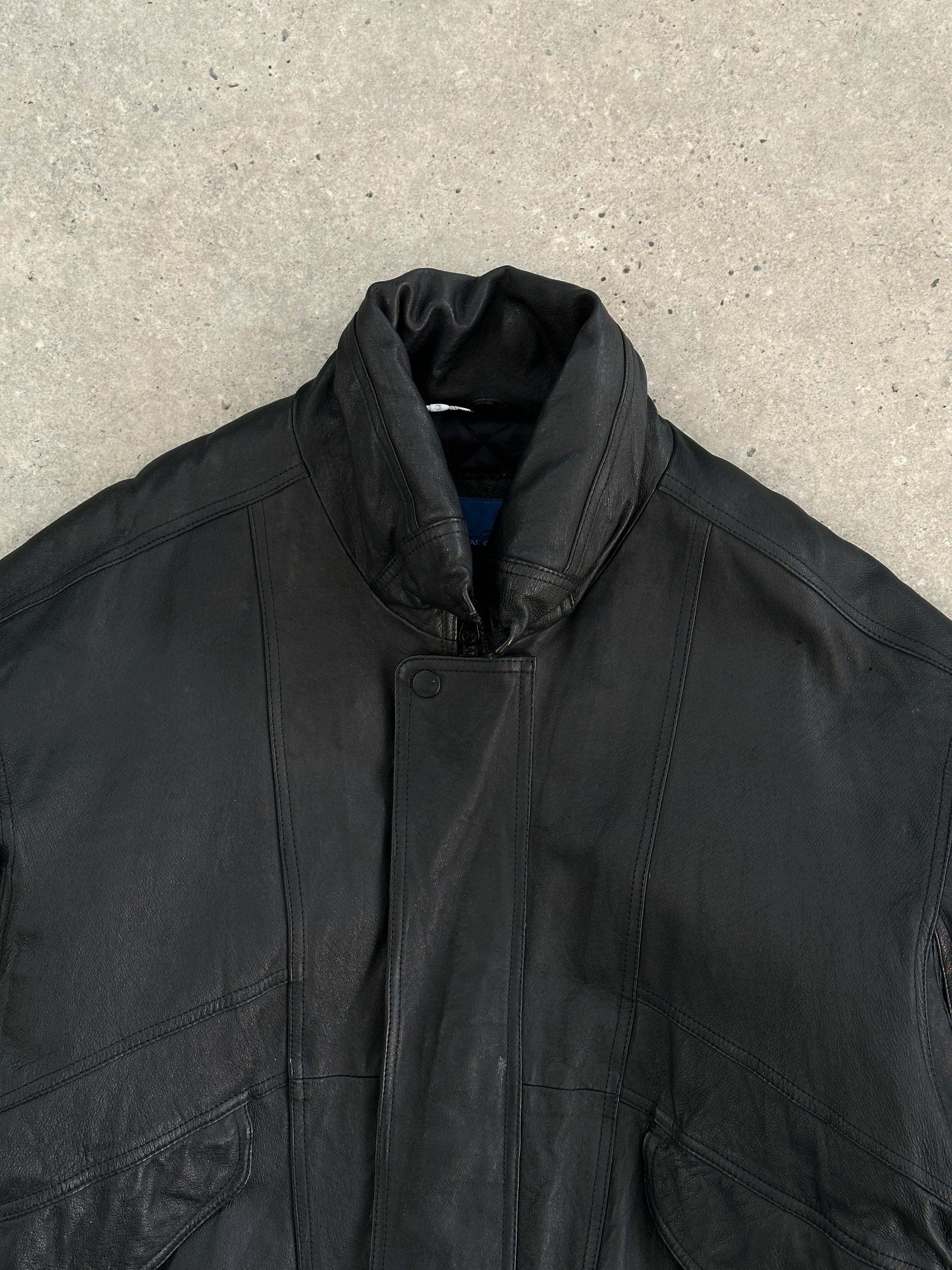 Vintage leather bomber jacket in size large, featuring classic design, smooth texture, and detailed stitching.