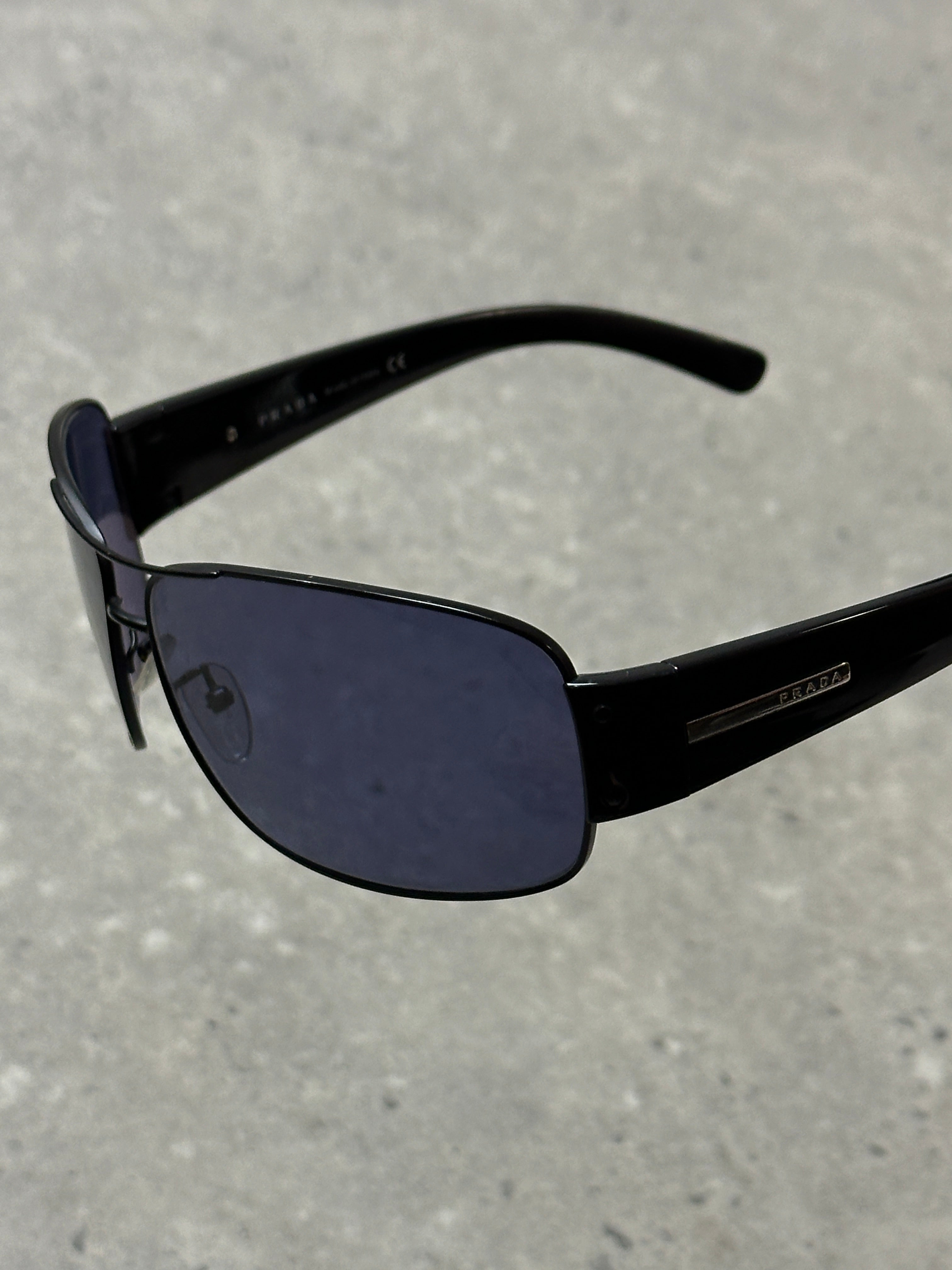Prada aviator shield sunglasses with dark tinted lenses and metal frame, stylish eyewear for sun protection and fashion.