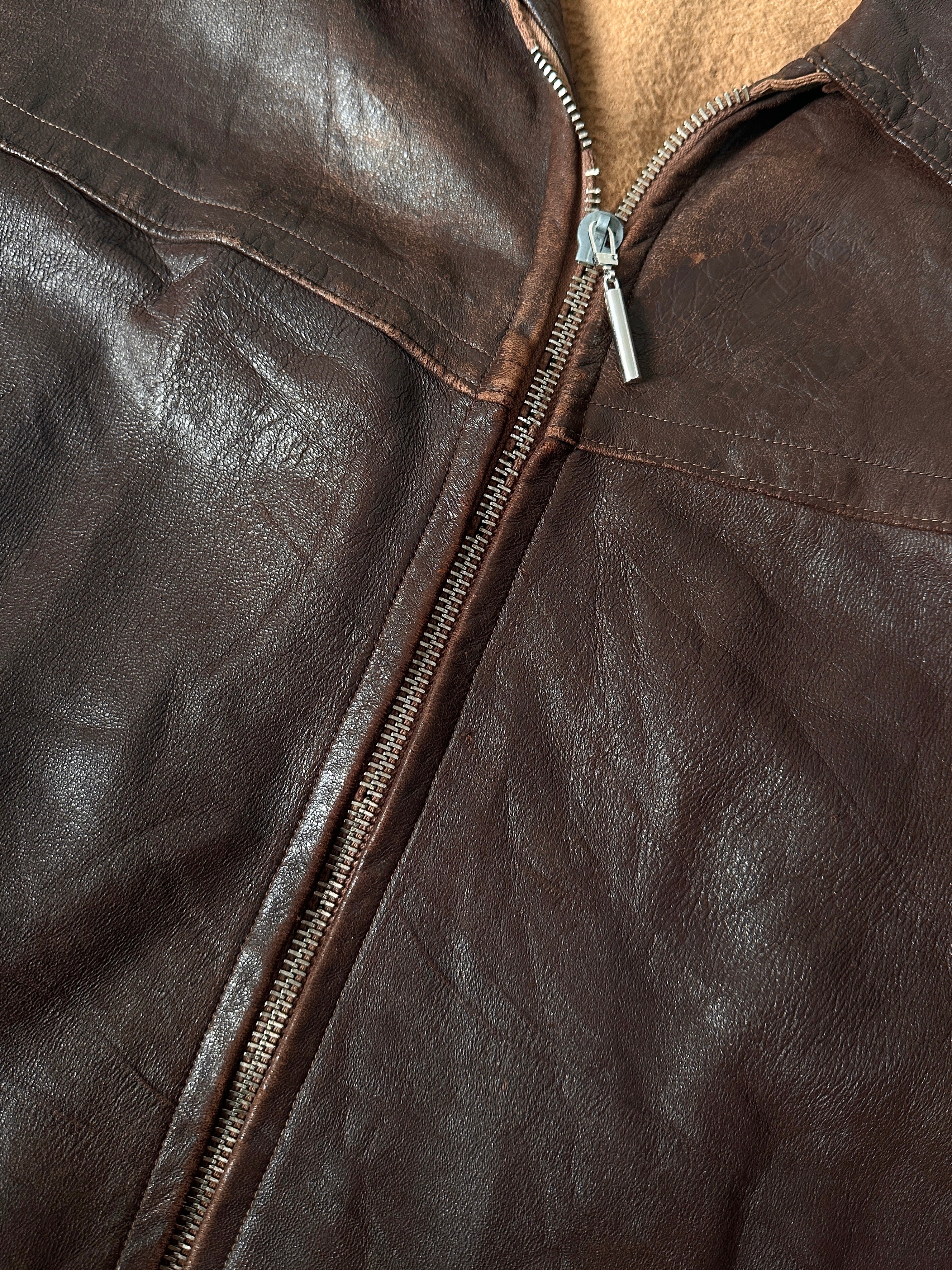 Vintage distressed leather jacket in XL, mid-length style with a rugged, vintage look and detailed stitching visible in the image.