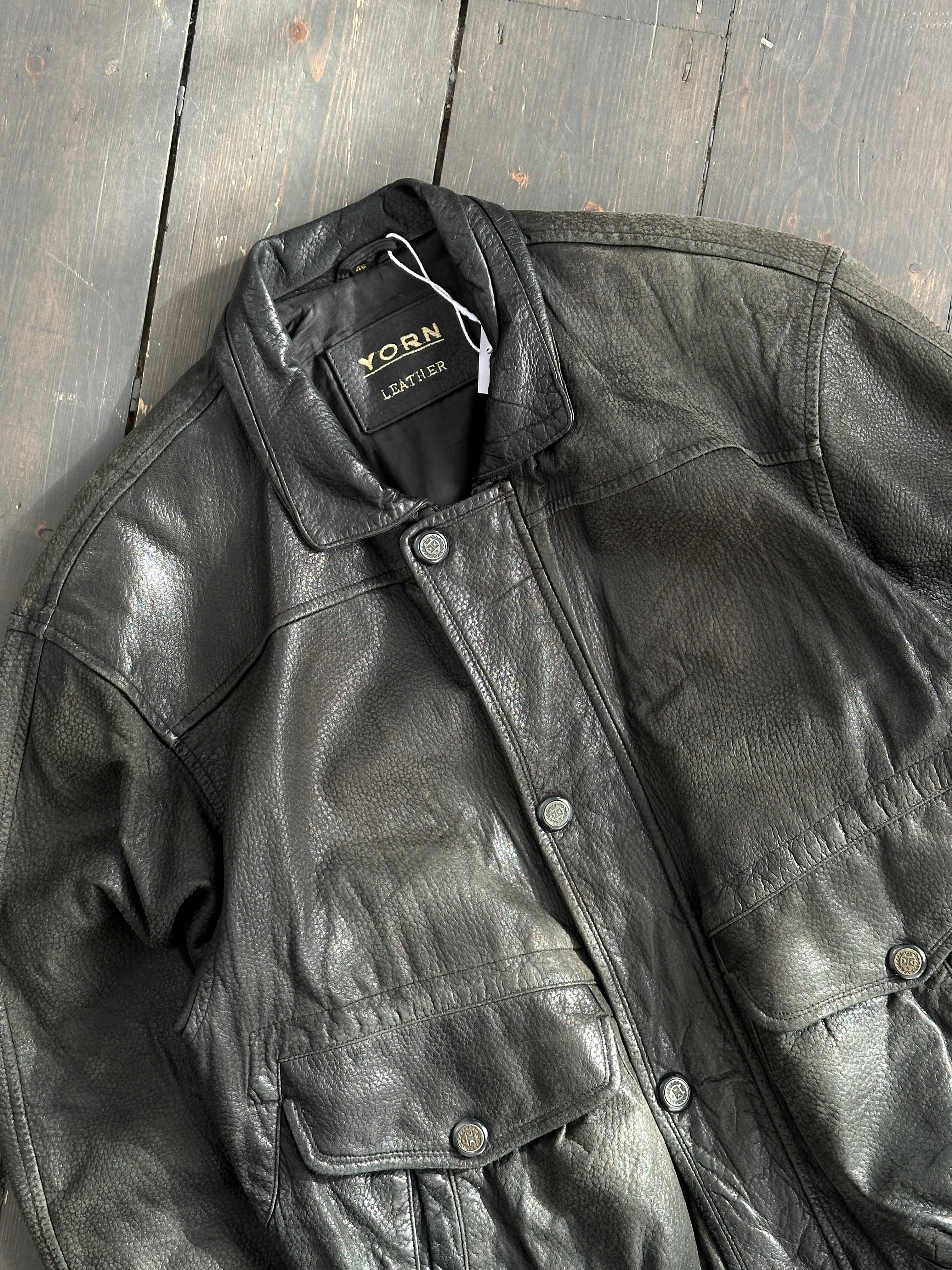 Vintage textured leather bomber jacket in M/L size, featuring classic design and distressed finish, displayed on a hanger.