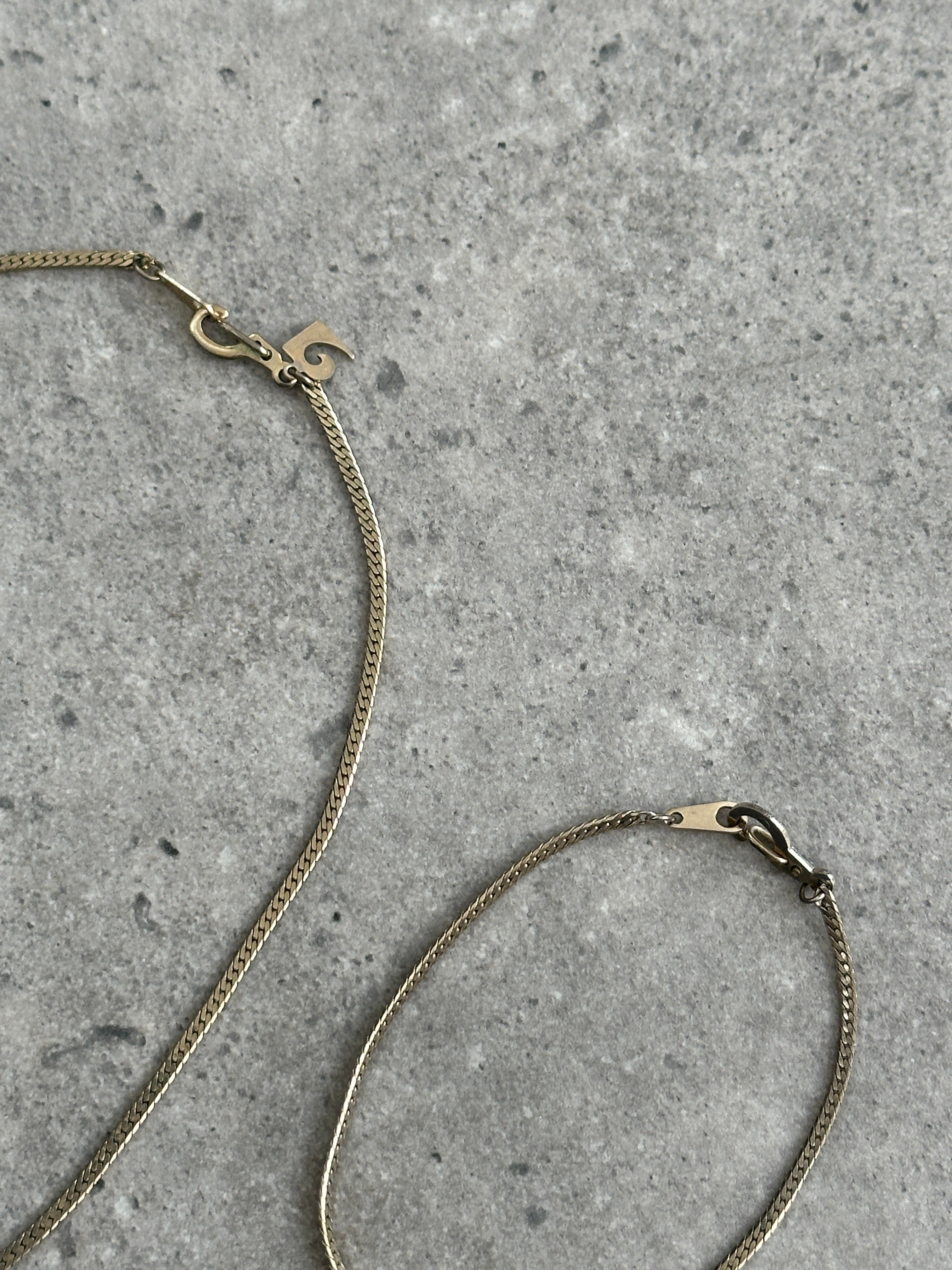 Pierre Cardin gold plated necklace and bracelet chain set, featuring elegant, matching jewelry with a sleek, polished finish.