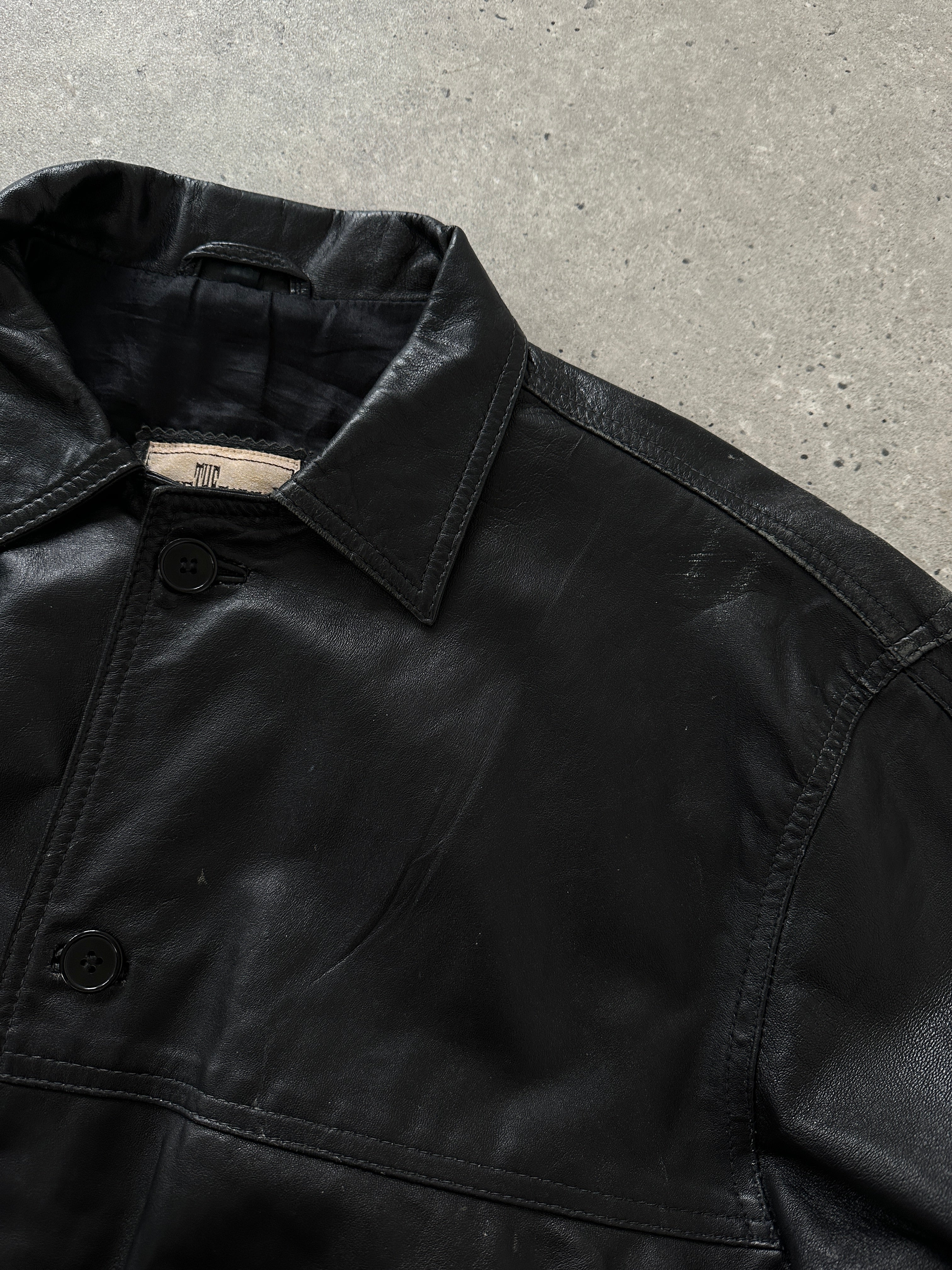 Vintage leather bomber jacket in size M, showcasing classic style with a smooth brown leather finish and ribbed collar.
