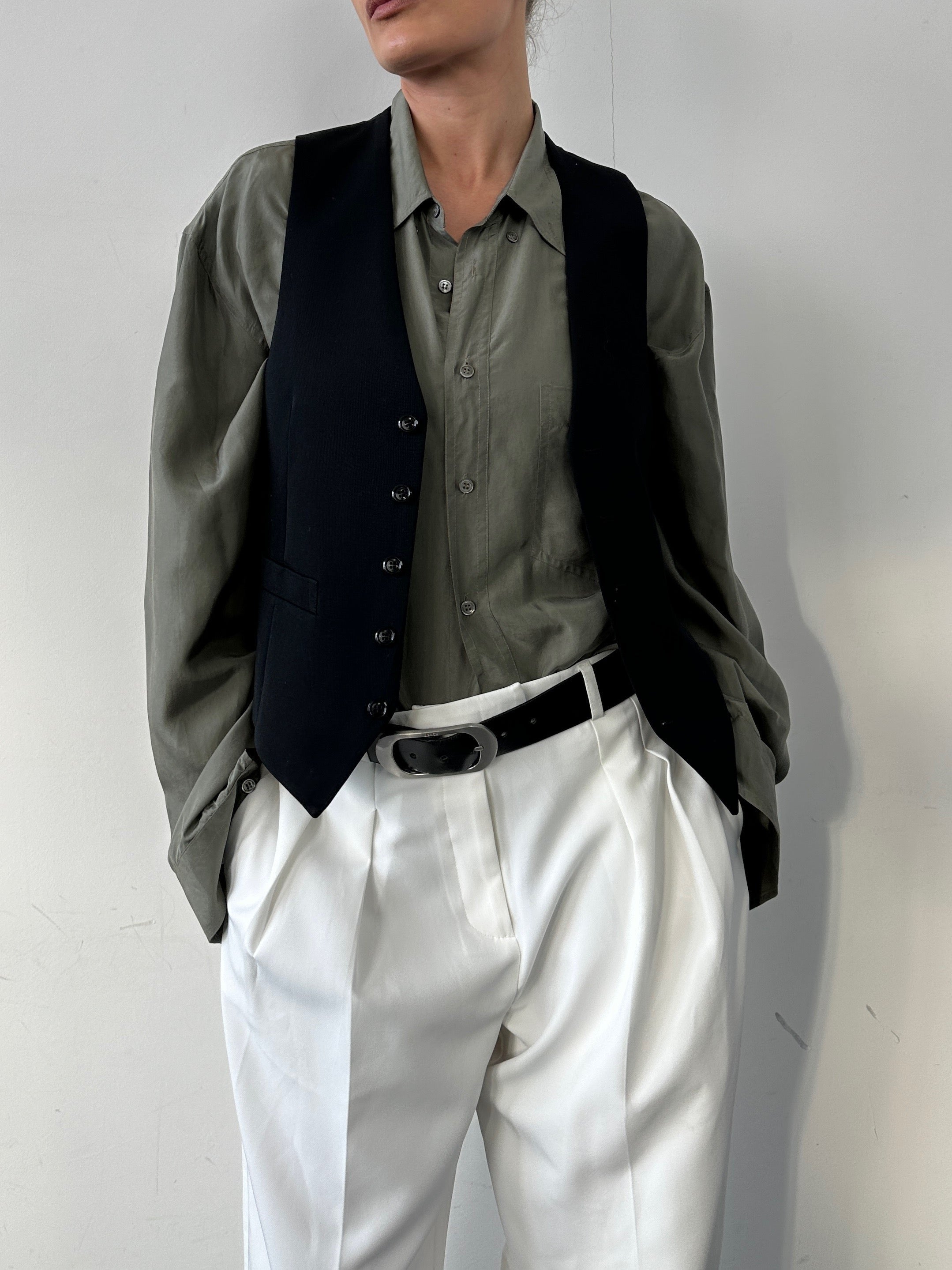 Vintage pure wool tailored waistcoat in size small, featuring a classic design with a structured fit and traditional tailoring details.