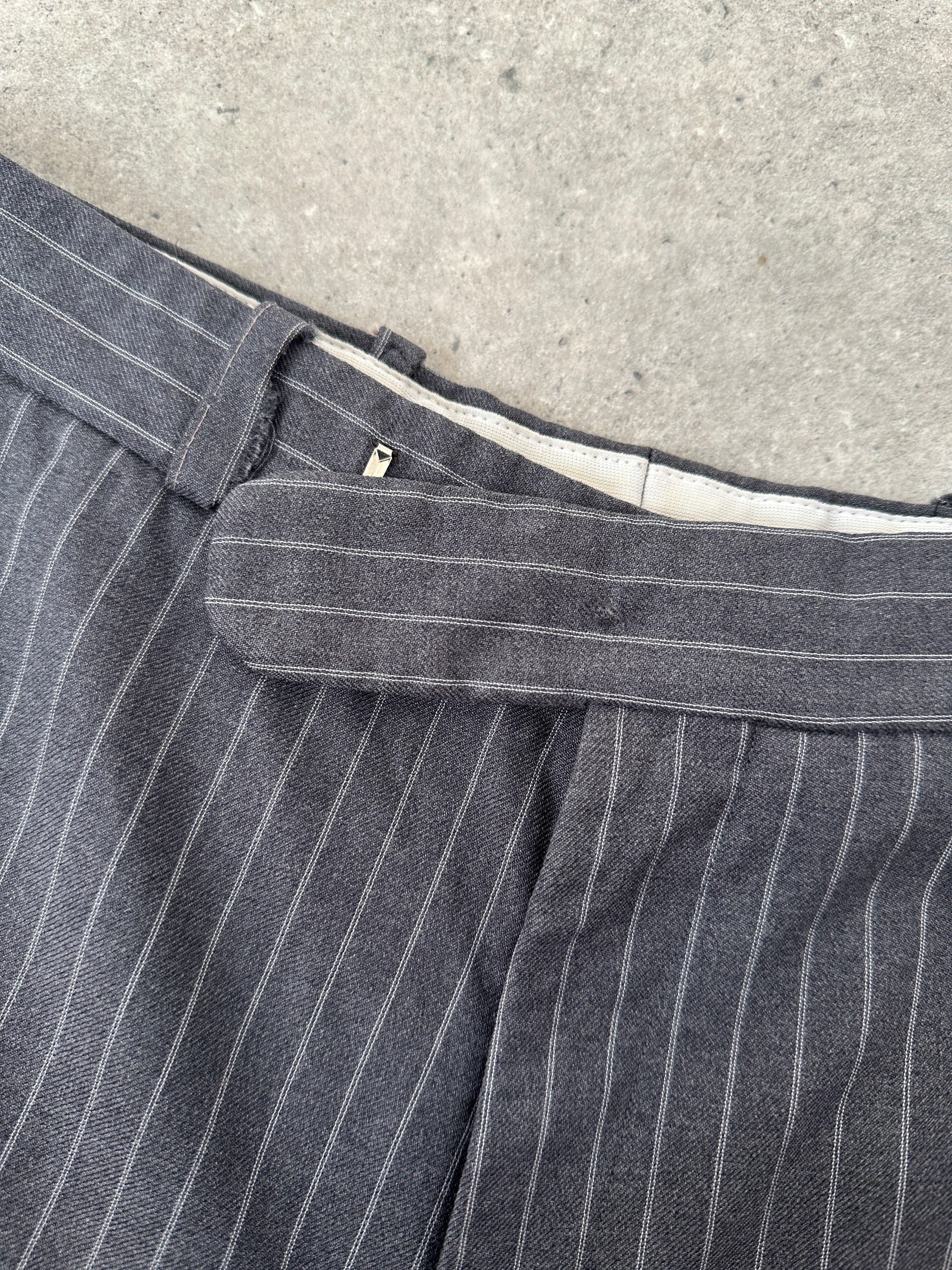 Christian Dior pinstripe wool mid-waist straight leg trousers in size W30, featuring tailored fit and classic pinstripe pattern.