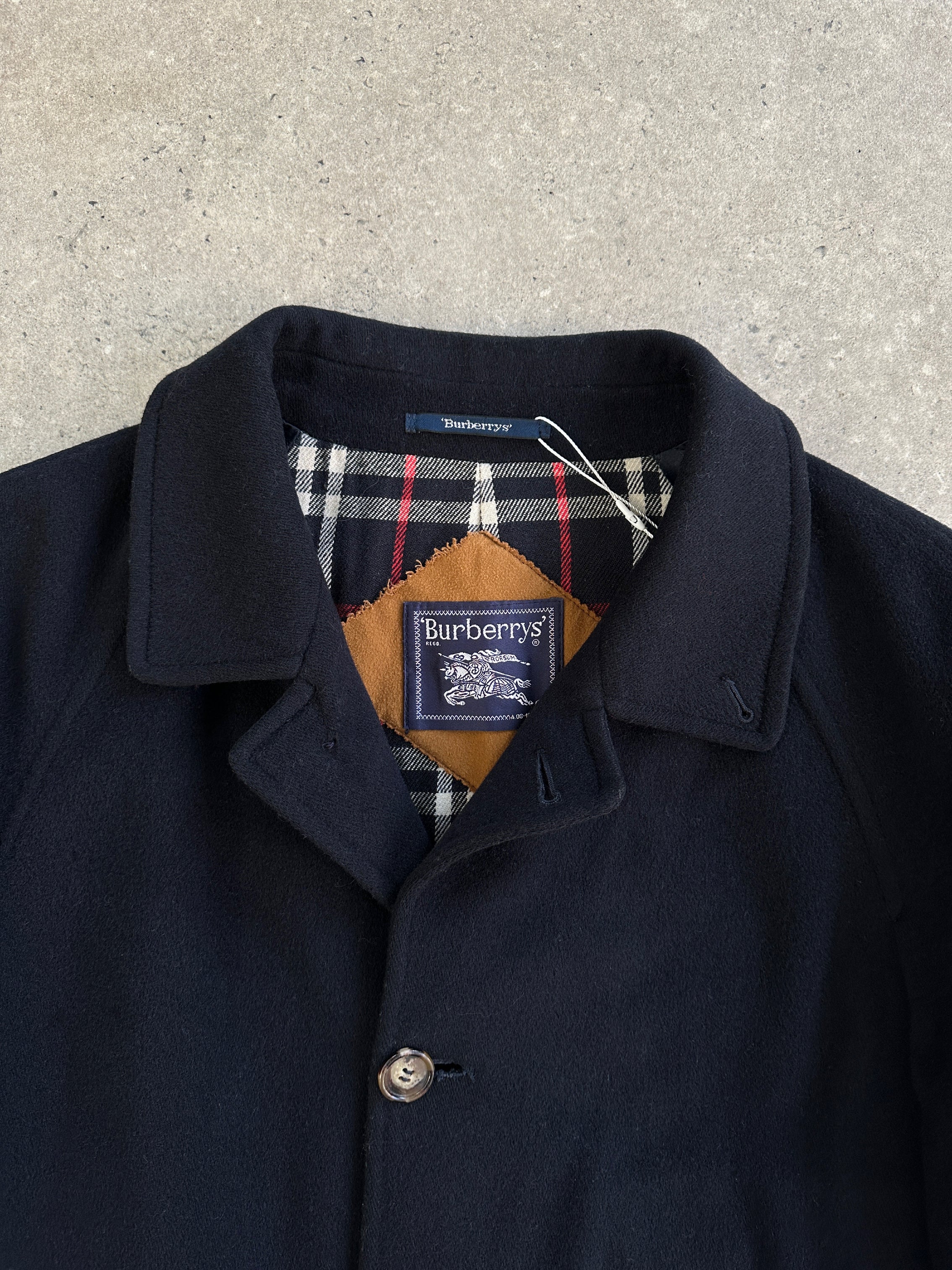 Burberry New Wool single-breasted coat in XL, featuring classic design and tailored fit, displayed on a hanger.