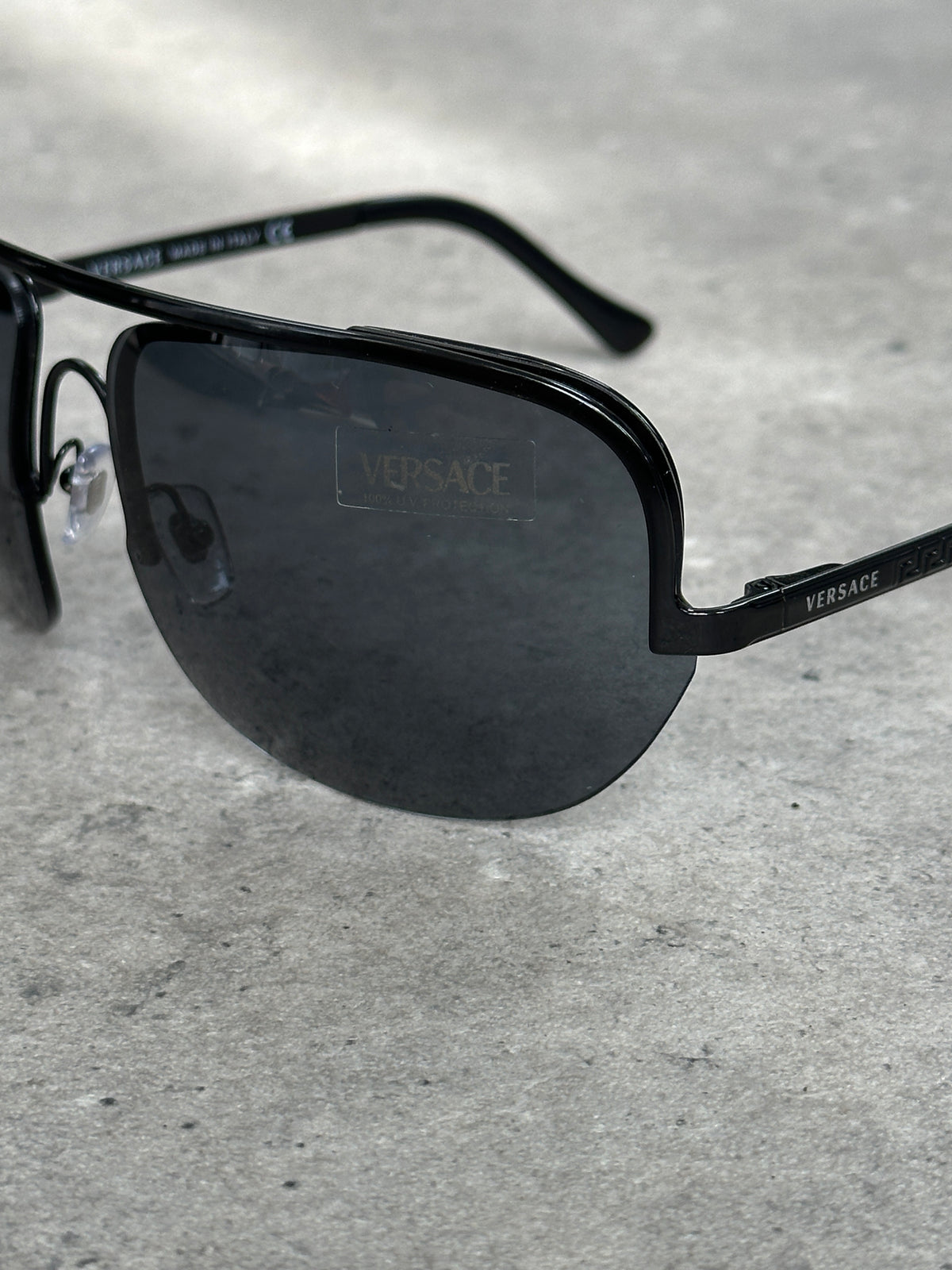 Versace 2000s shield aviator logo sunglasses with bold frames and iconic Versace branding, stylish eyewear for a fashionable look.