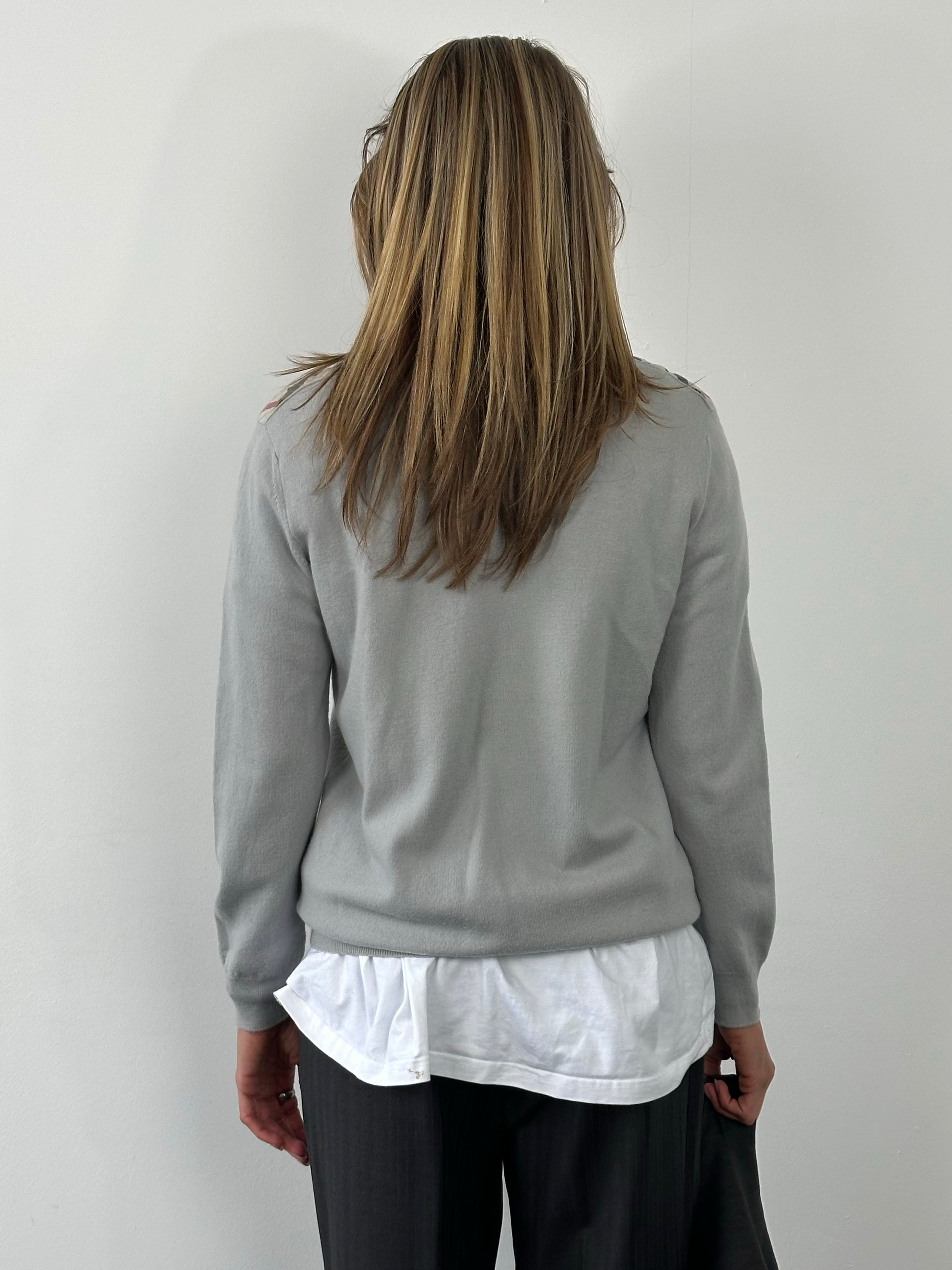 Burberry Brit 2000s merino wool V-neck jumper in size M, featuring classic design and craftsmanship, shown on a plain background.