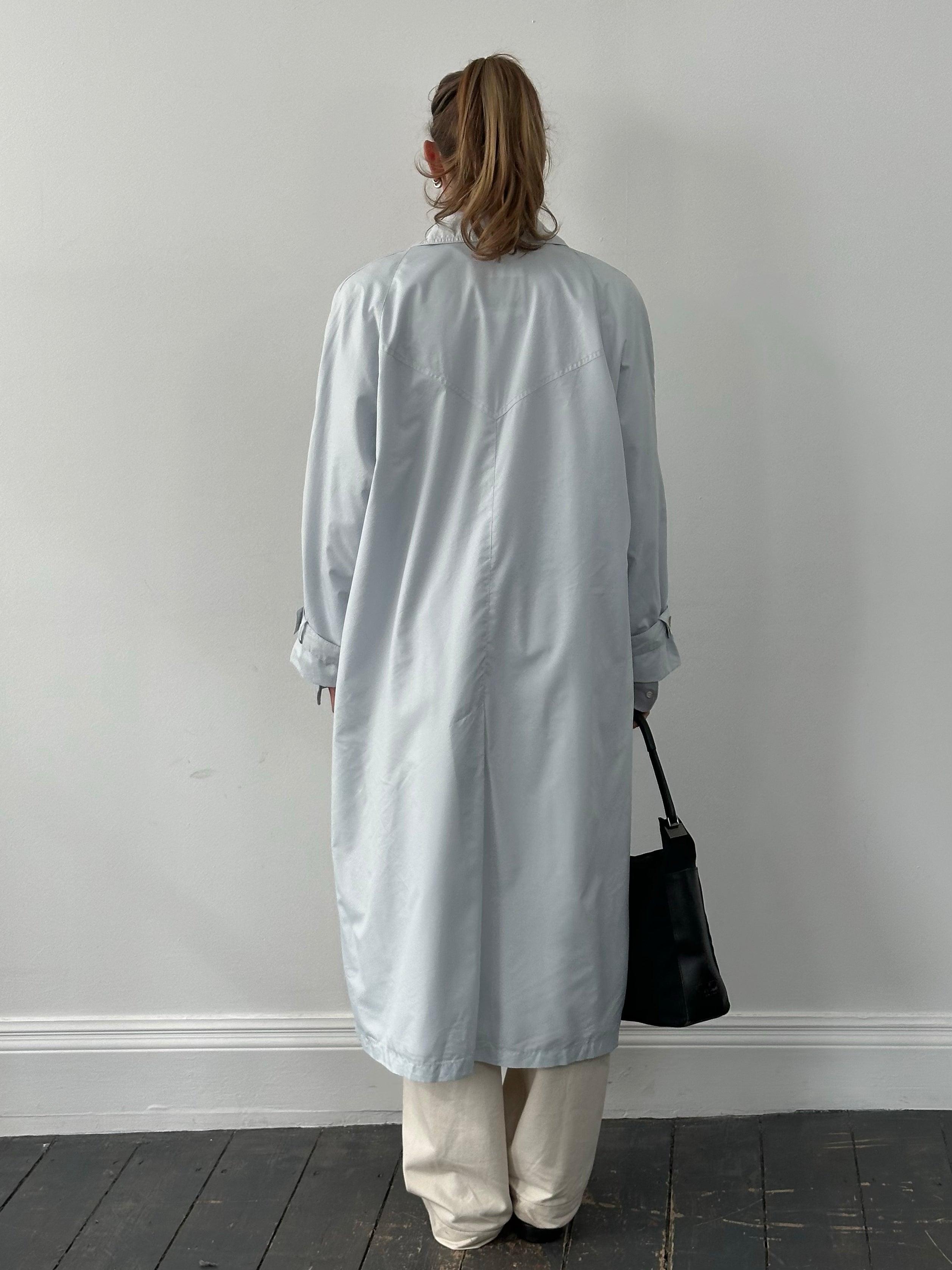 London Fog 1990s XL trench coat with concealed placket, classic beige color, shown hanging on a neutral background.