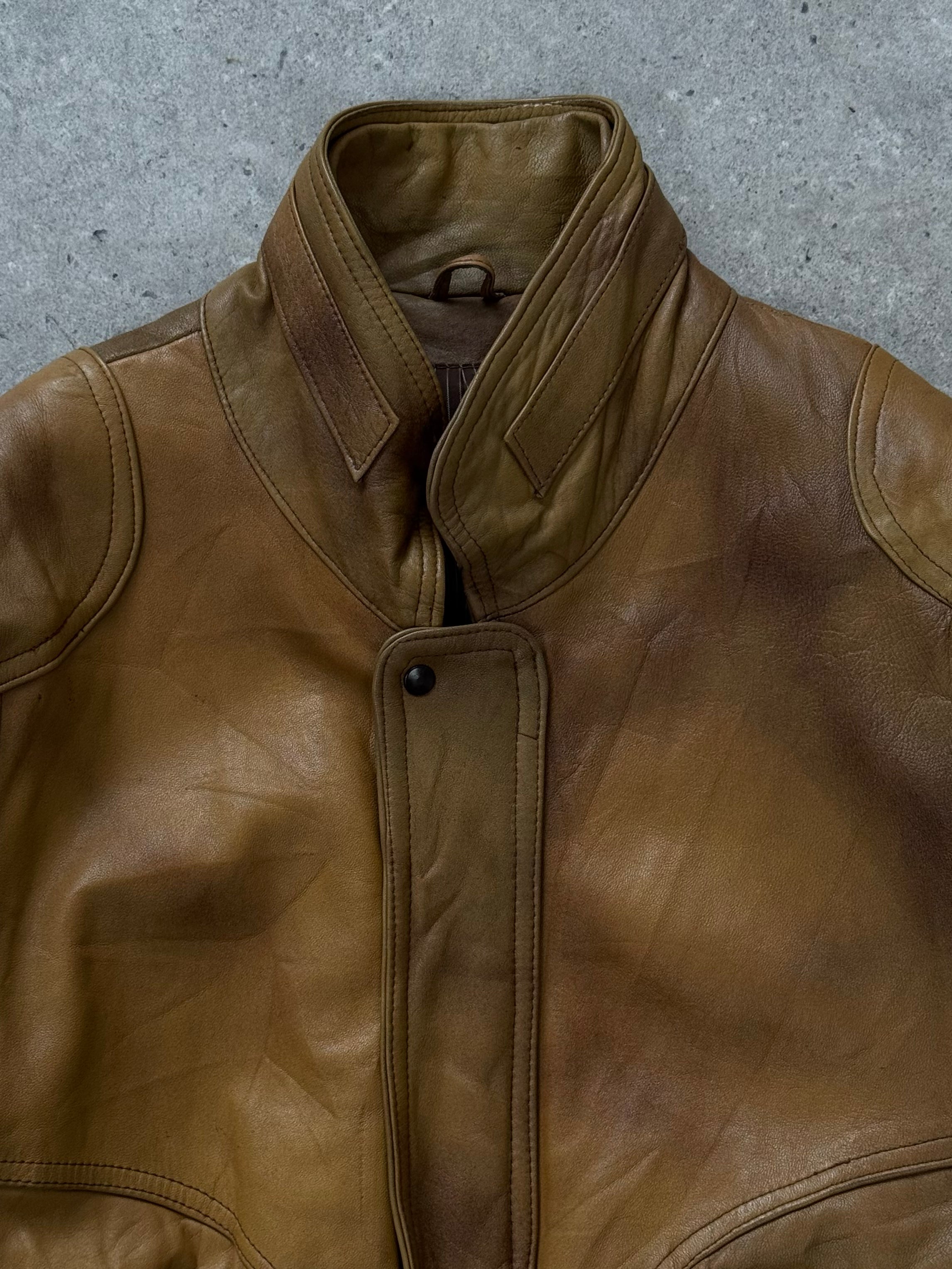 Vintage 1990s leather bomber jacket with high neck, classic fit, and zip closure, showcasing rugged leather and vintage style.