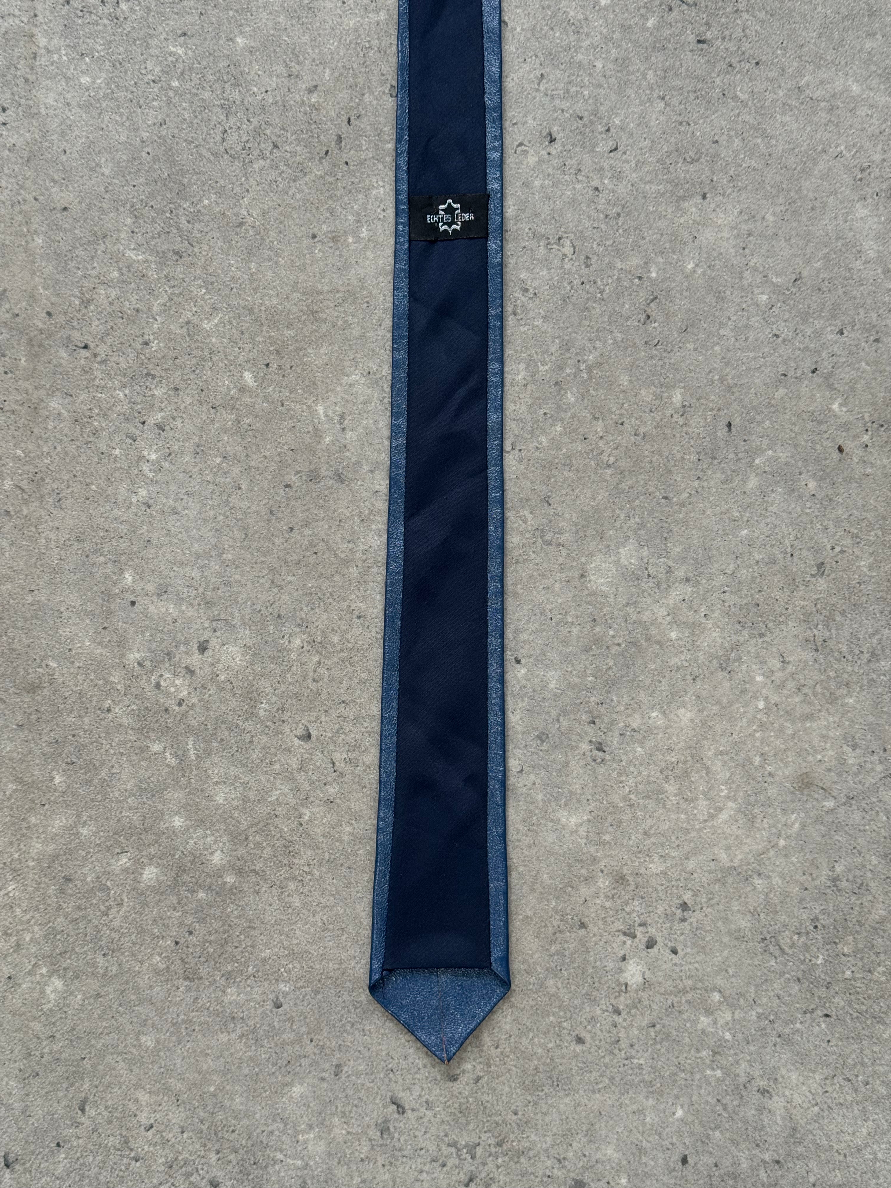 Vintage 1980s leather skinny tie with textured finish, stylish accessory for retro fashion and formal outfits.