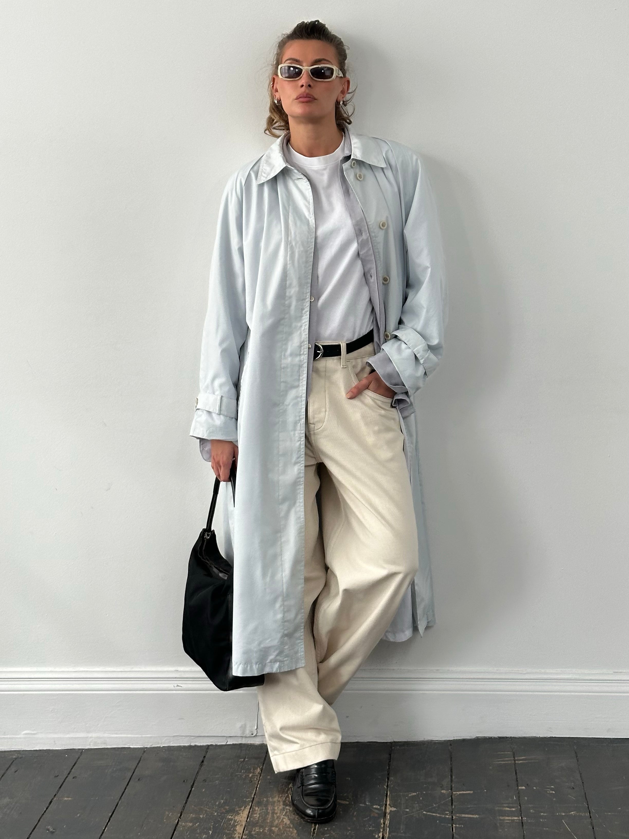 London Fog 1990s concealed placket trench coat in XL displayed on a hanger, showcasing classic beige fabric and double-breasted style.