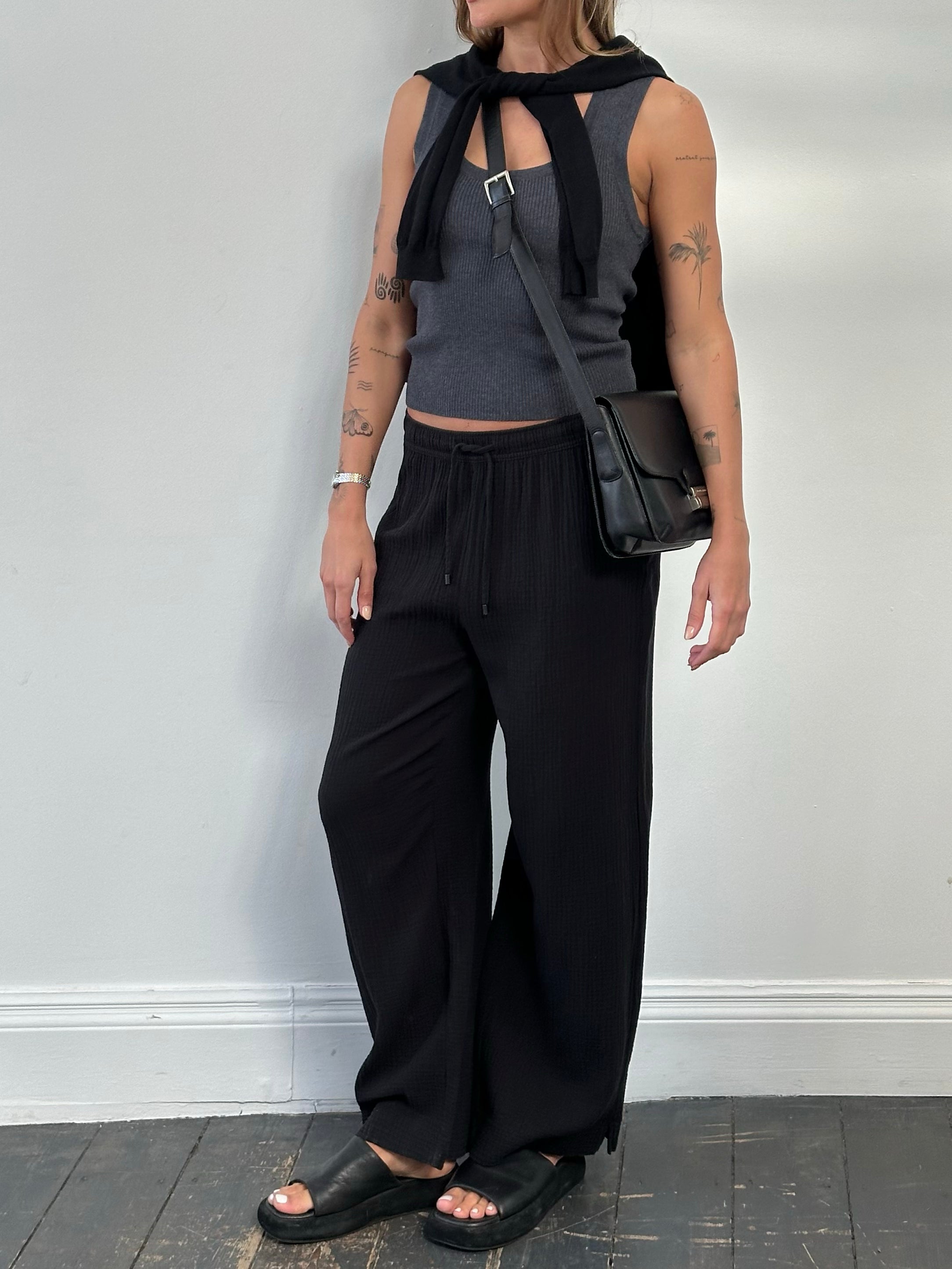 DKNY 2000s pure cotton wide-leg trousers in natural fabric, displayed on a hanger with a relaxed fit and high waist.