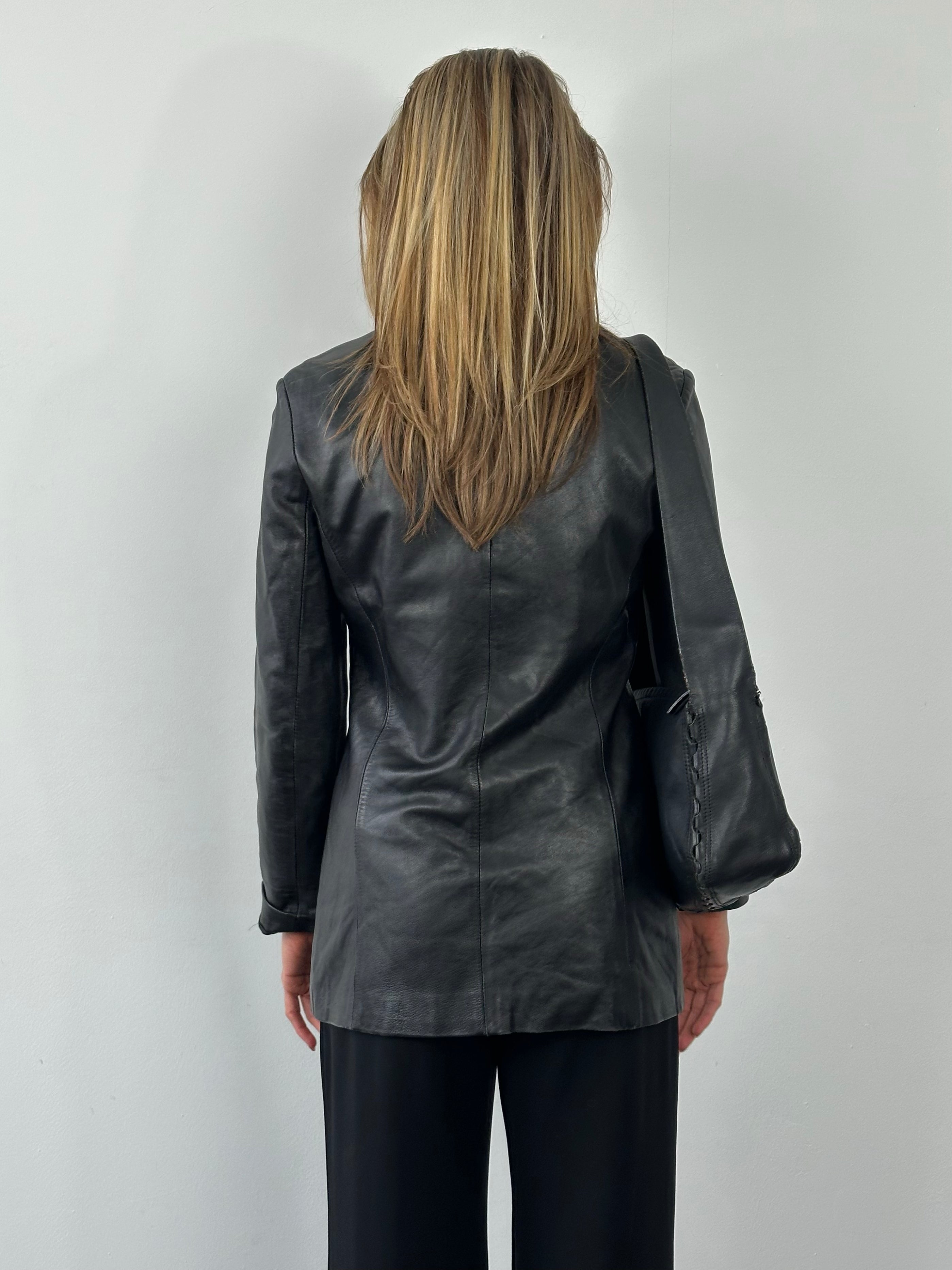 Vintage British 1990s fitted leather jacket in black, showcasing classic design and structured fit, from the Vintage brand.