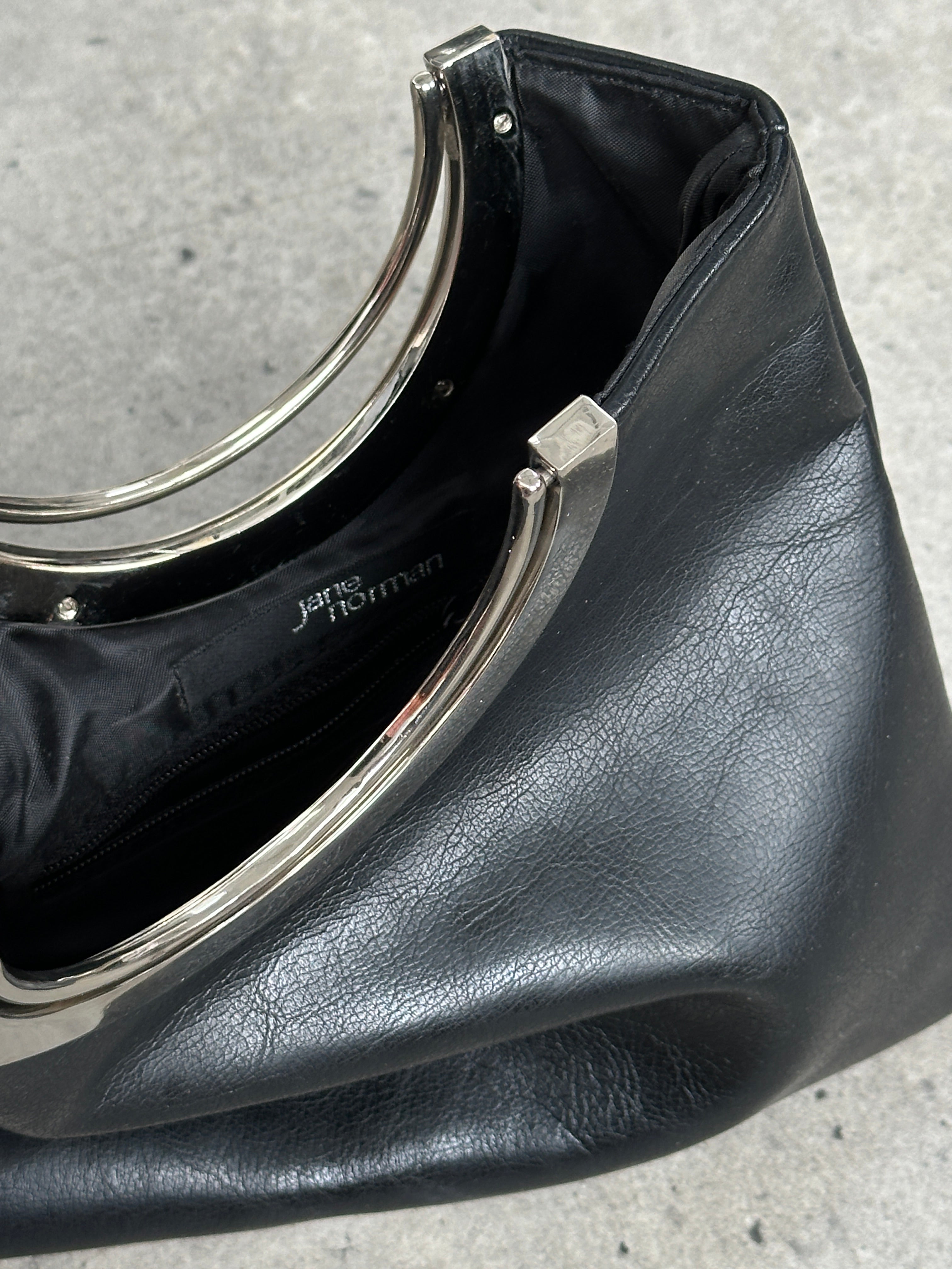 Vintage 1990s minimal leather bag with sleek design, featuring a smooth leather surface and a compact, stylish silhouette.