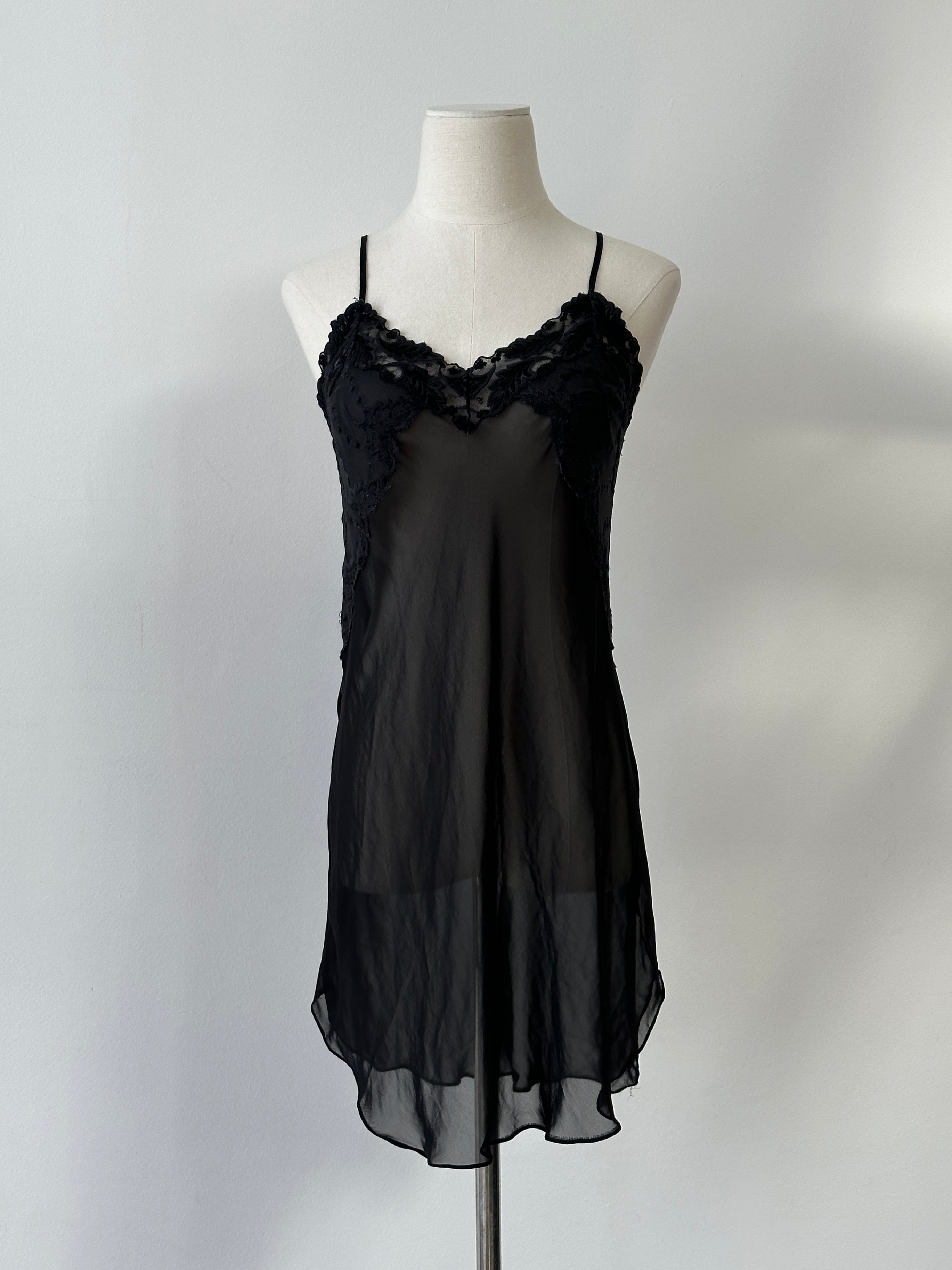 Vintage 2000s sheer mini slip dress in black with thin straps and a fitted silhouette, perfect for retro-inspired fashion.