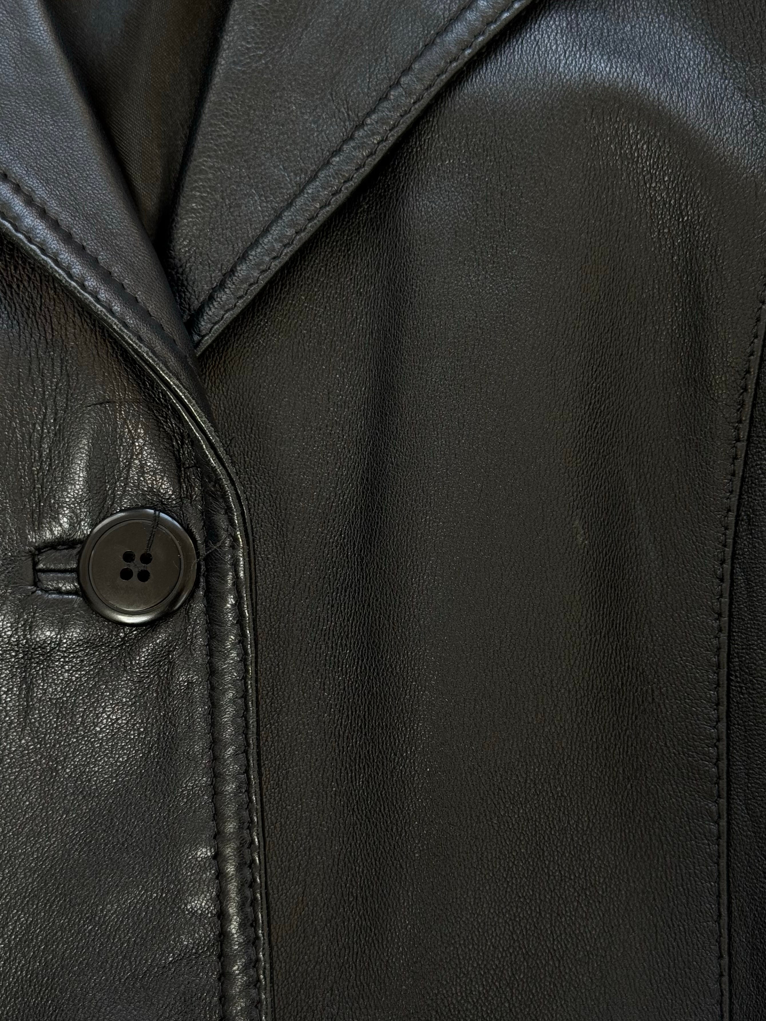 Vintage 1990s fitted leather jacket in classic brown leather, showing front view with collar and zip closure.