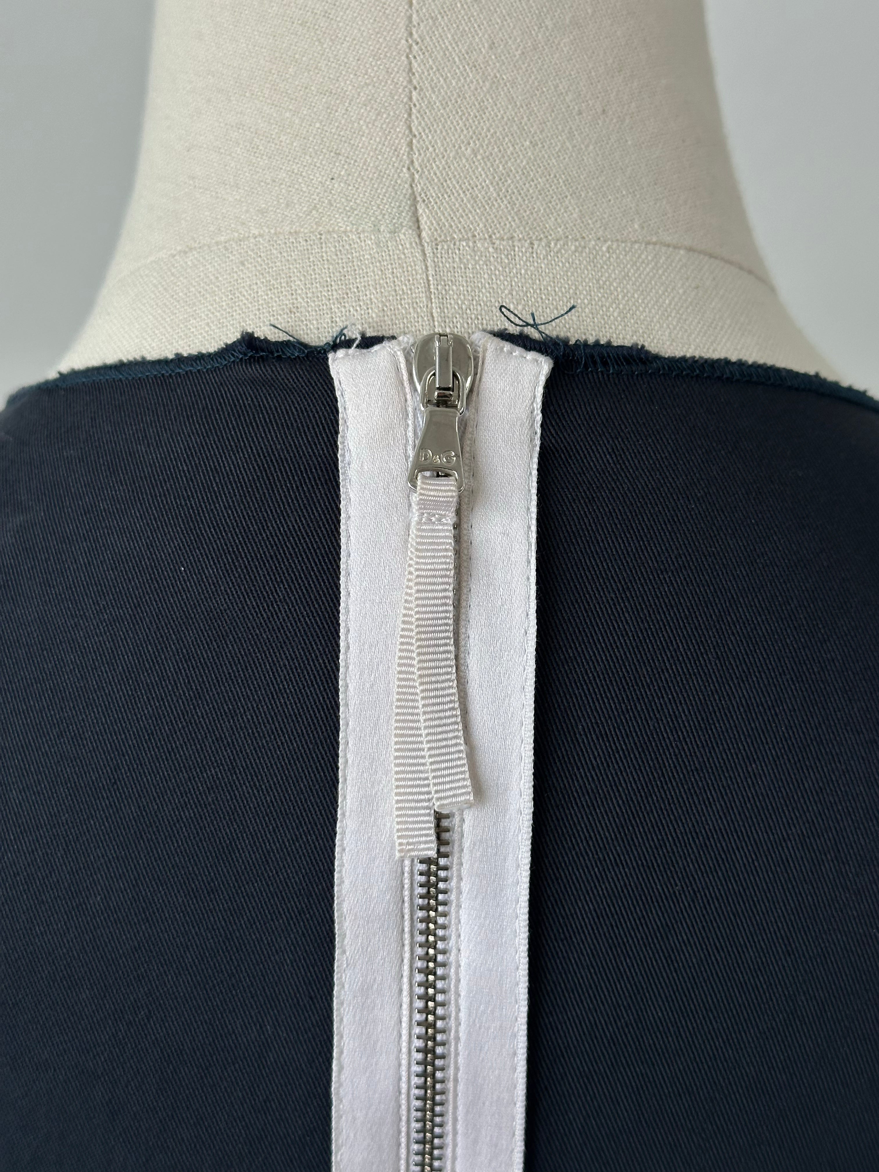 Dolce & Gabbana 2000s cotton fitted mini dress in white, showing a close-up of the tailored bodice and short sleeves.