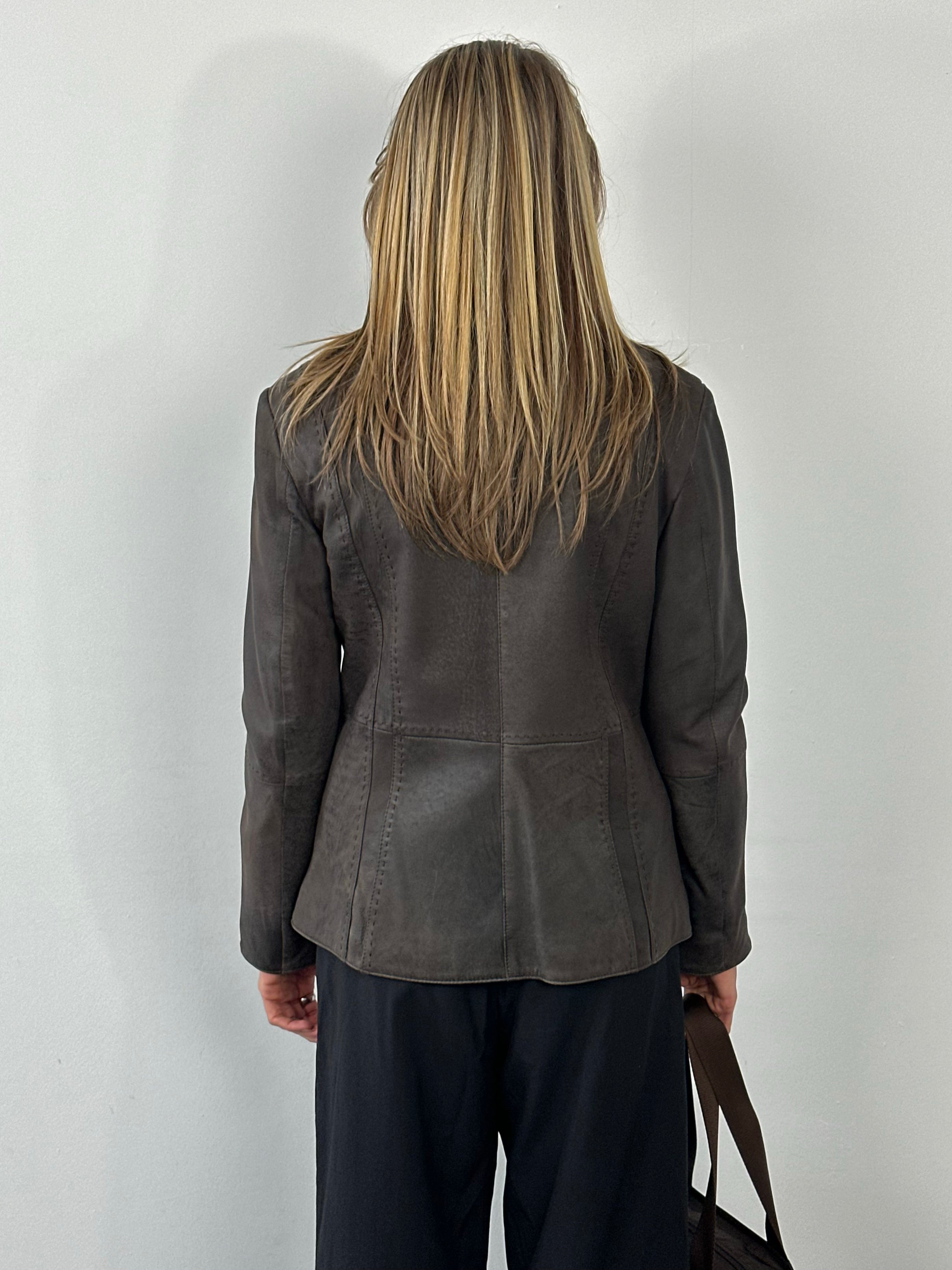 Vintage 1990s leather high neck jacket, size small, featuring classic leather texture and a high collar design.