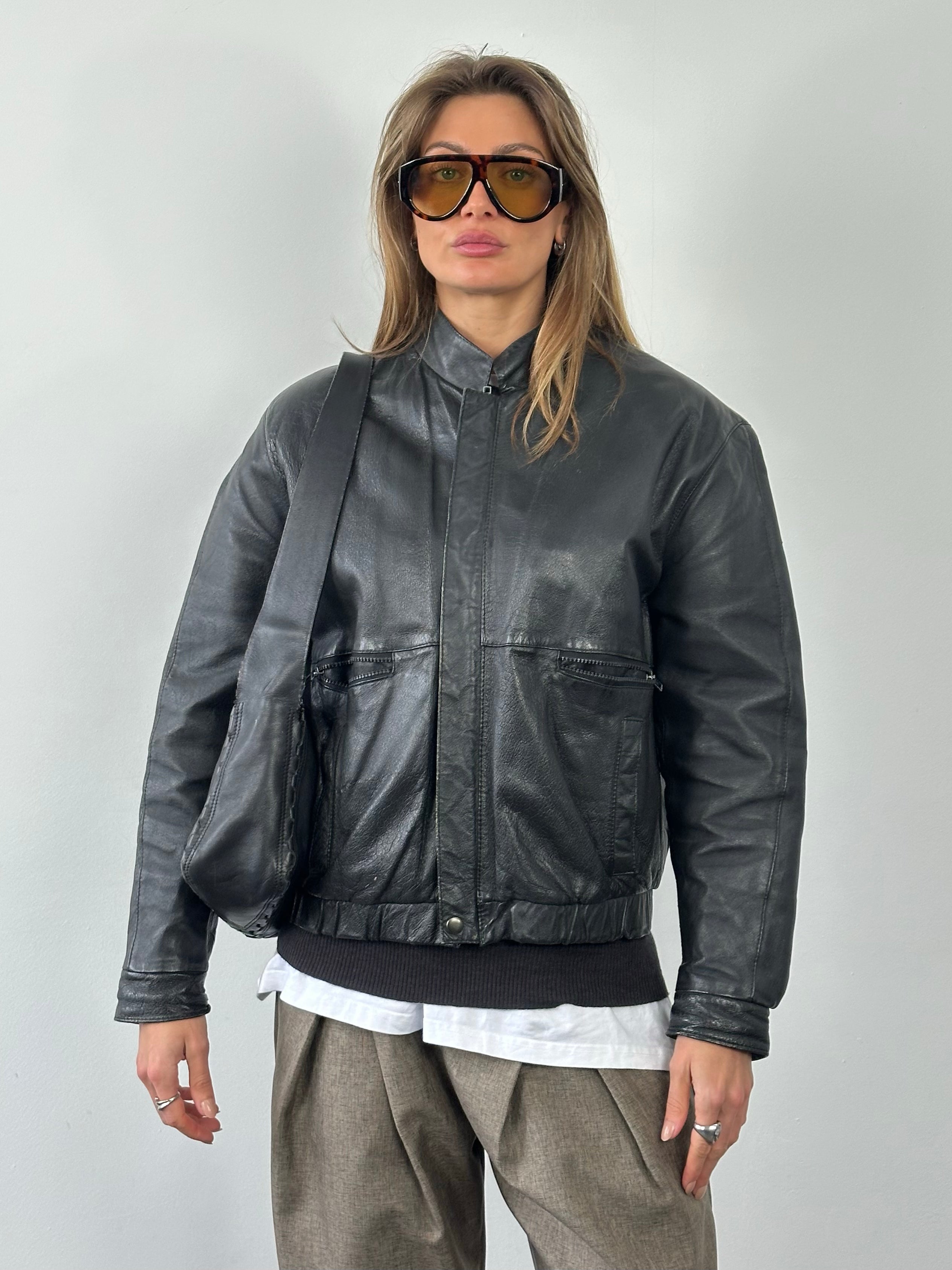 Vintage 1990s minimal leather jacket for men, featuring classic design and black leather material.
