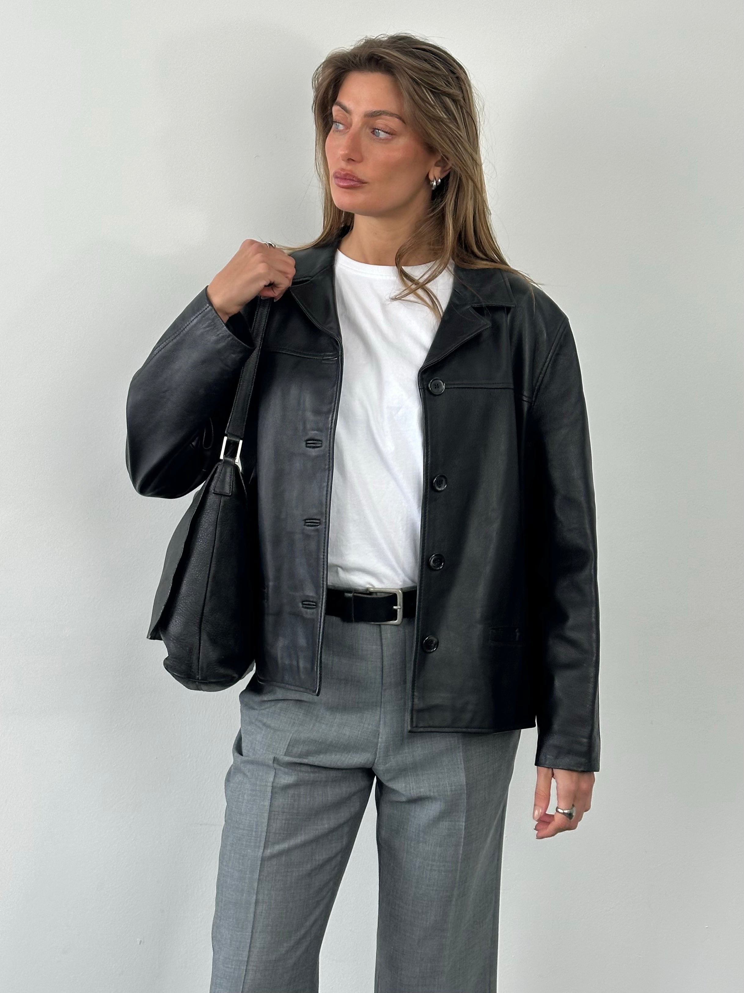 Vintage 1990s boxy leather jacket in size M, featuring classic black leather with a cropped fit and structured design.