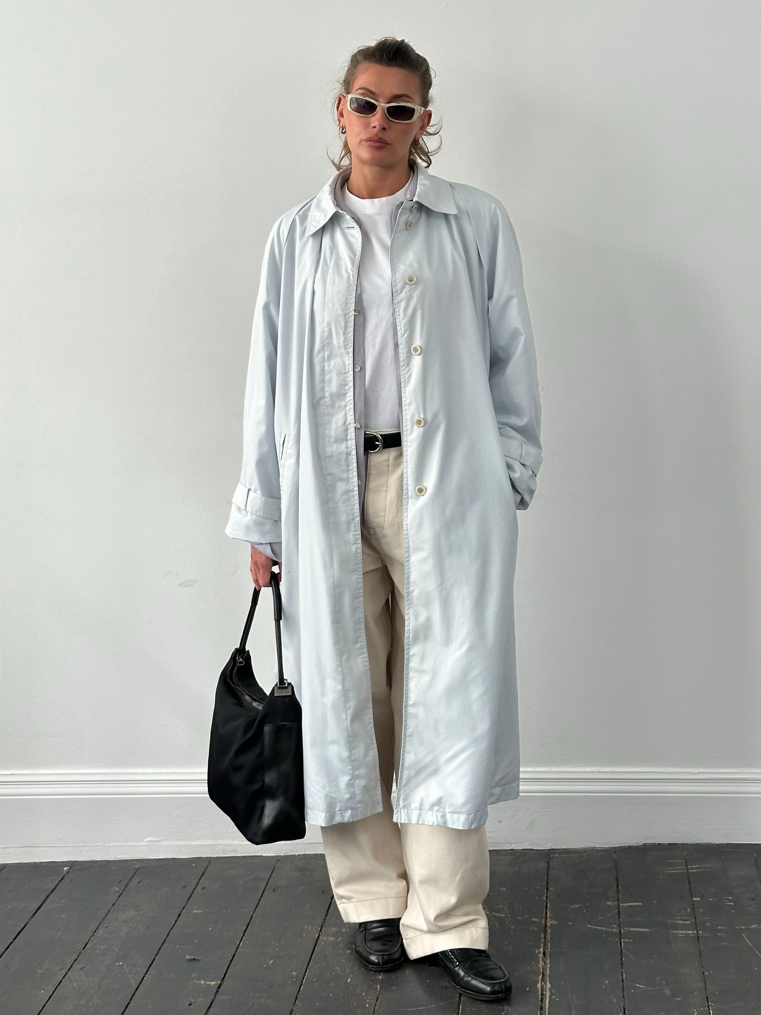 London Fog 1990s concealed placket trench coat in XL, showing khaki fabric, adjustable waist belt, and classic trench design.