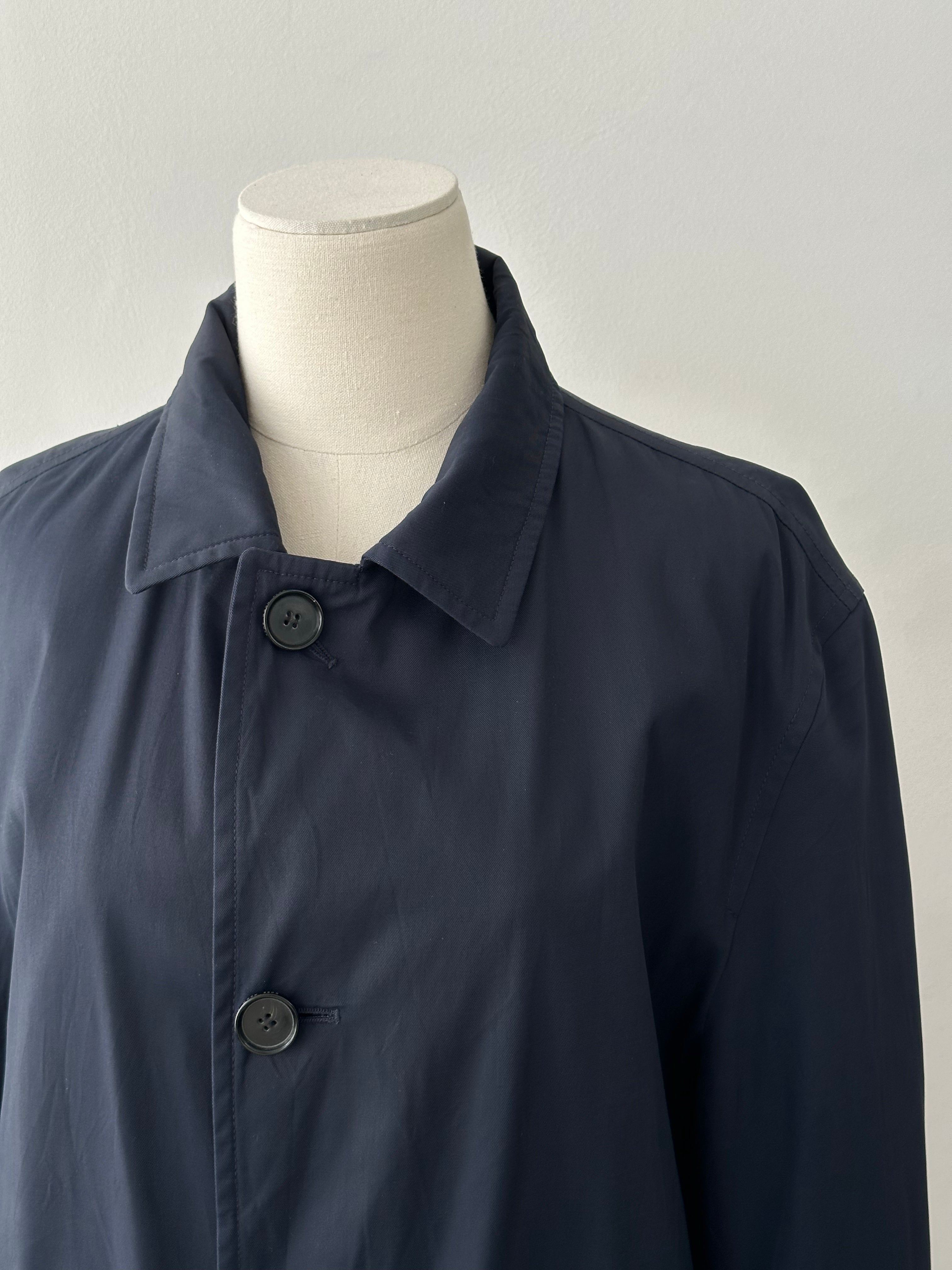 Hugo Boss 2000s cotton water-repellent trench coat in size L, shown hanging with a classic beige design and button details.