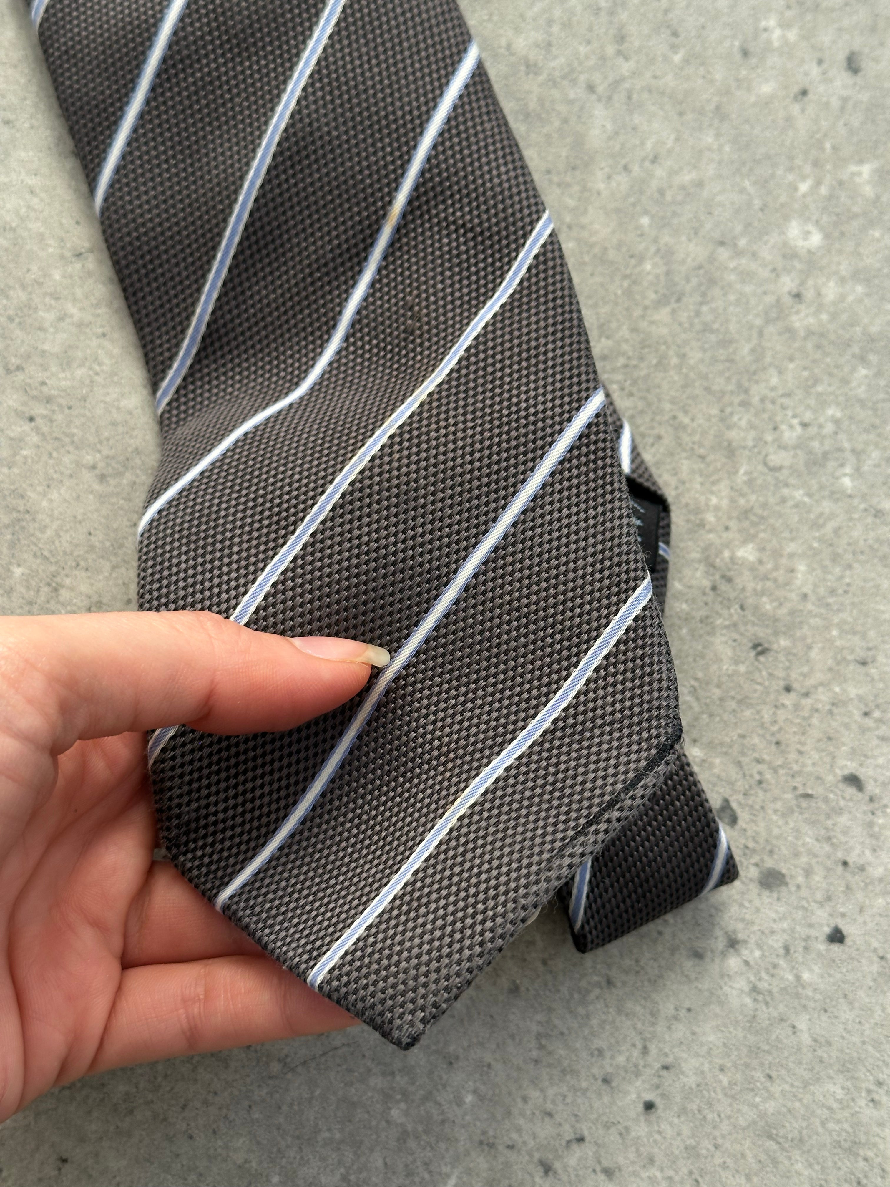 Burberry Black Label 2000s pure silk striped tie with classic pattern, featuring navy, red, and white stripes, laid flat on a neutral background.