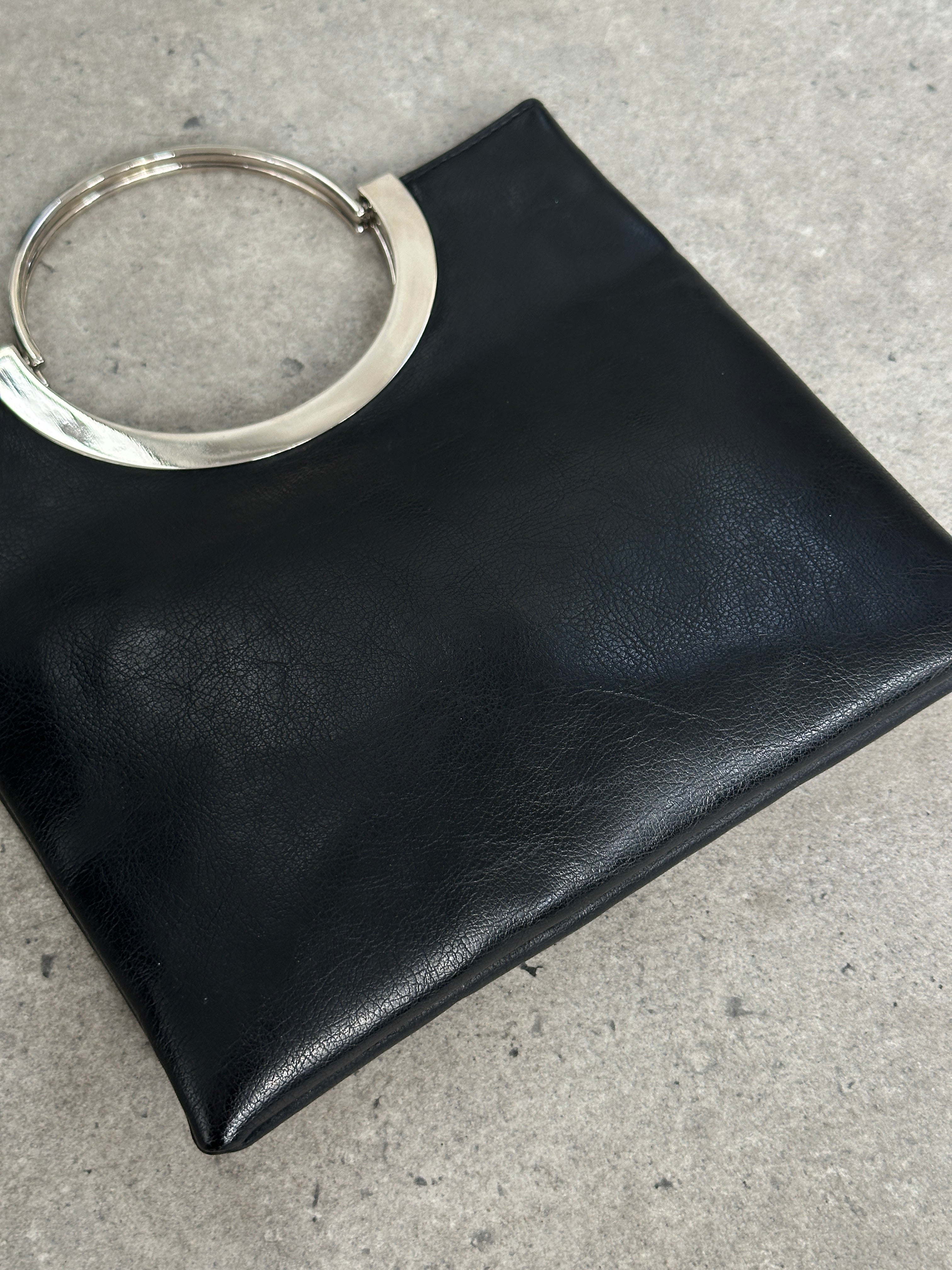 Vintage 1990s minimal leather bag with sleek design and clean lines, showcasing a classic, timeless accessory from the Vintage brand.