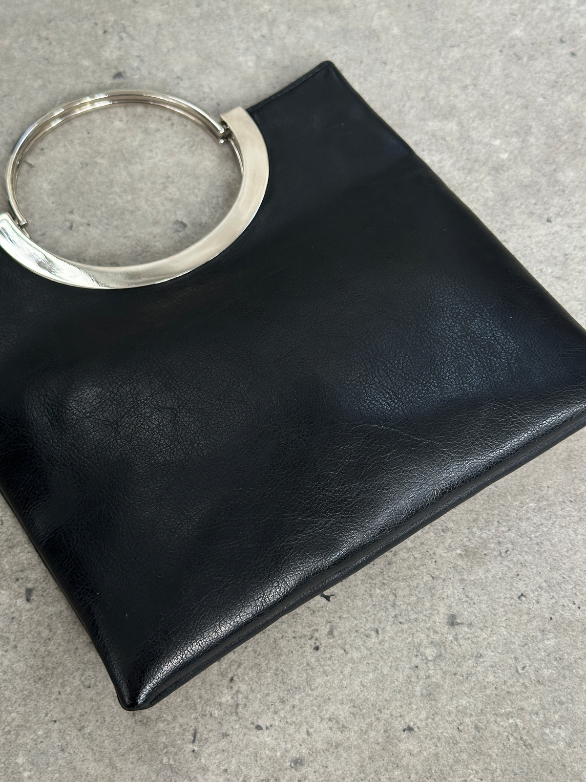 Vintage 1990s minimal leather bag with sleek design and clean lines, showcasing a classic, timeless accessory from the Vintage brand.