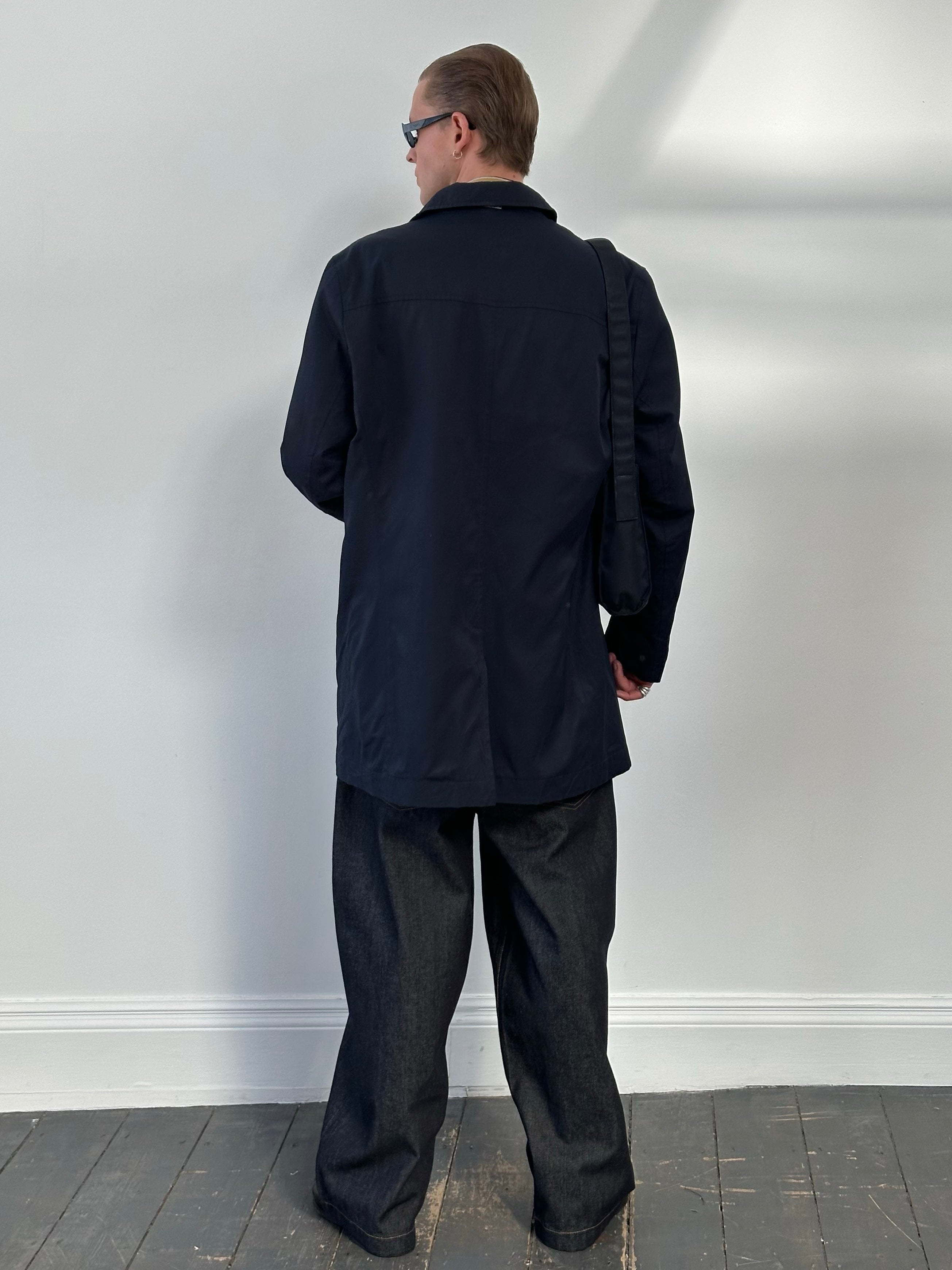 Hugo Boss 2000s cotton water-repellent trench coat in size L, shown hanging, with classic design and beige color.