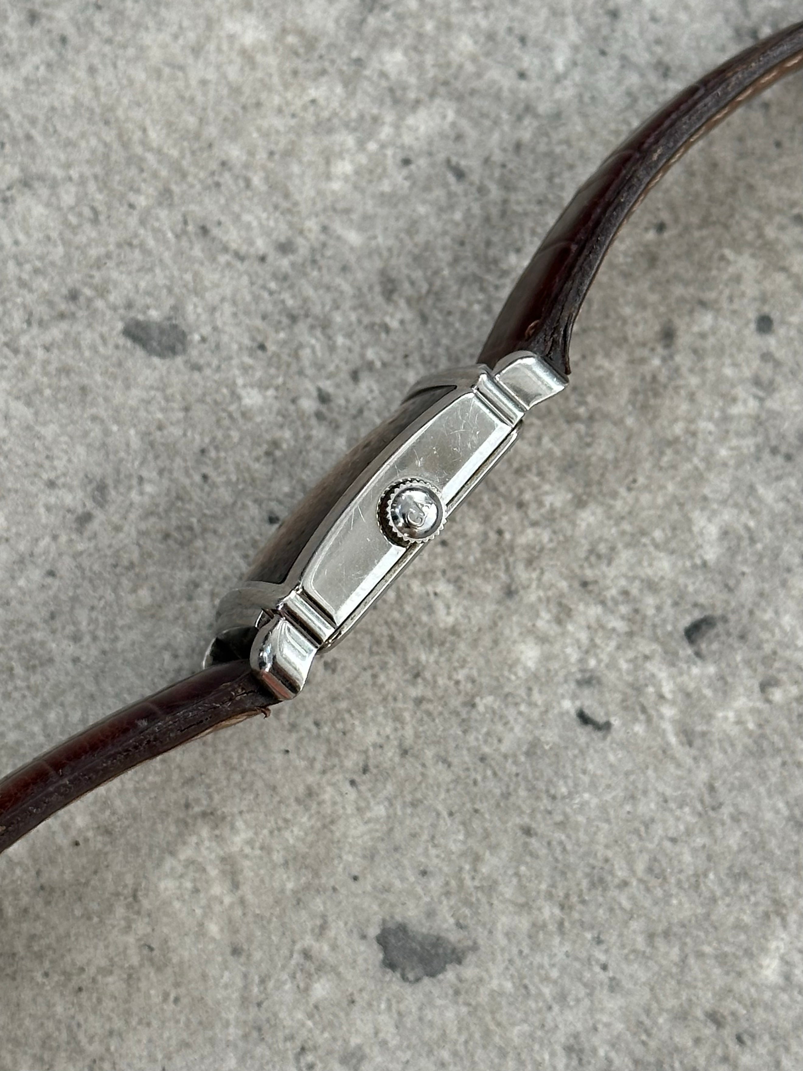 Emporio Armani leather logo watch with round dial and sleek black strap, showcasing classic 2000s style and branding.