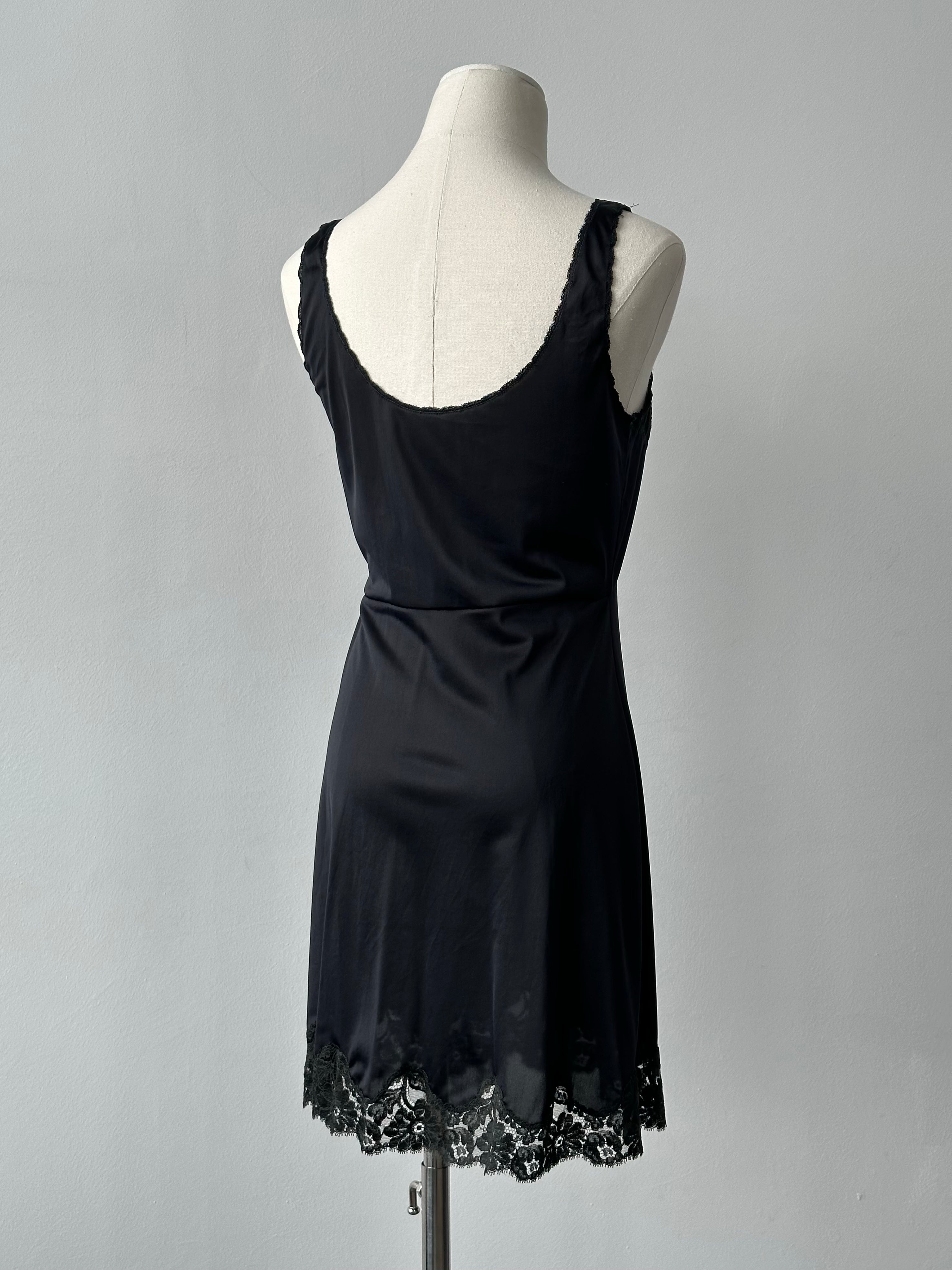 Vintage Italian 1990s lace mini dress, small size, featuring intricate lace fabric and a classic fit, displayed on a neutral background.