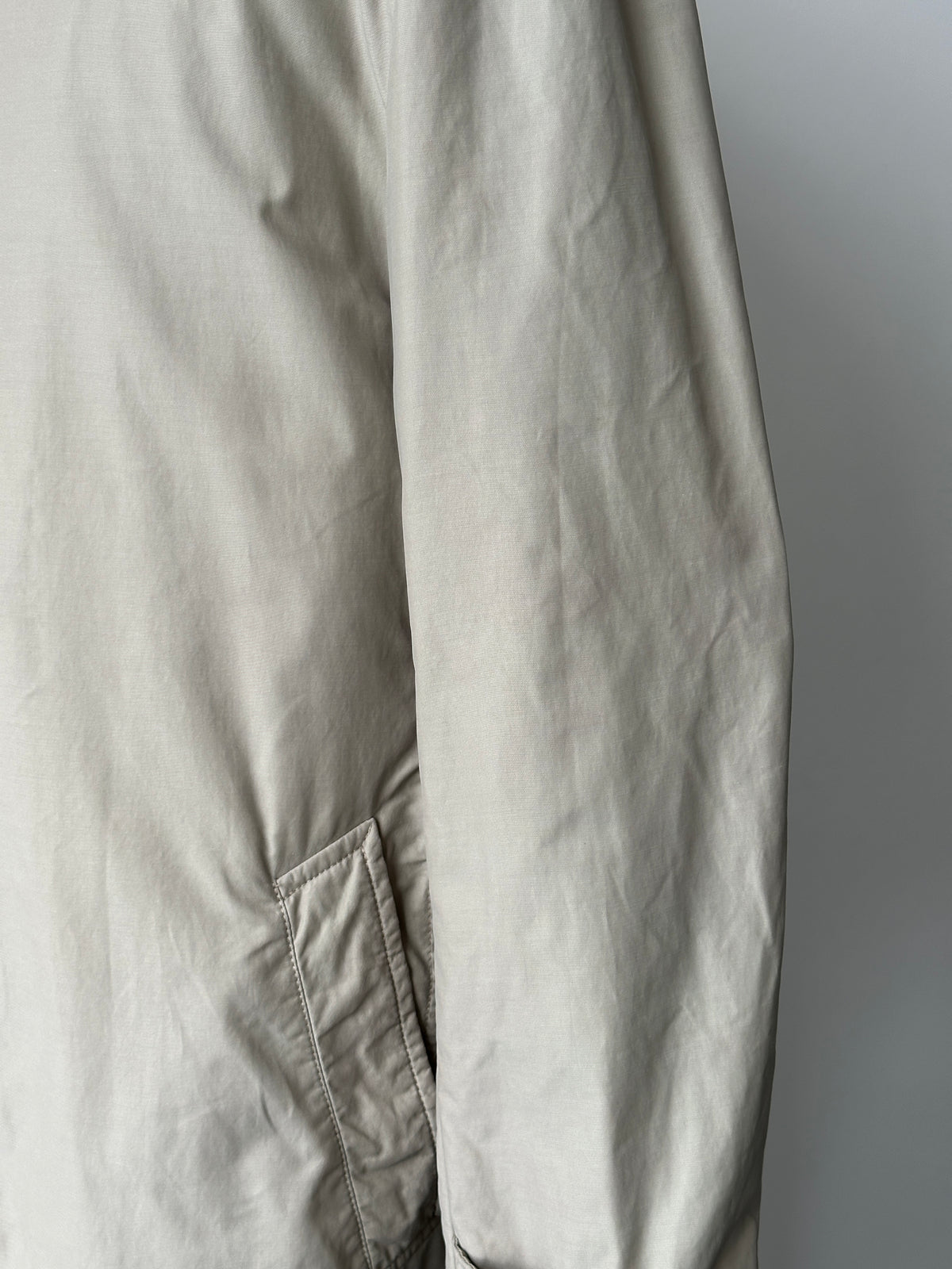 Hugo Boss 2000s high neck belted trench coat in beige, featuring a waist belt and classic trench style, shown on a model.