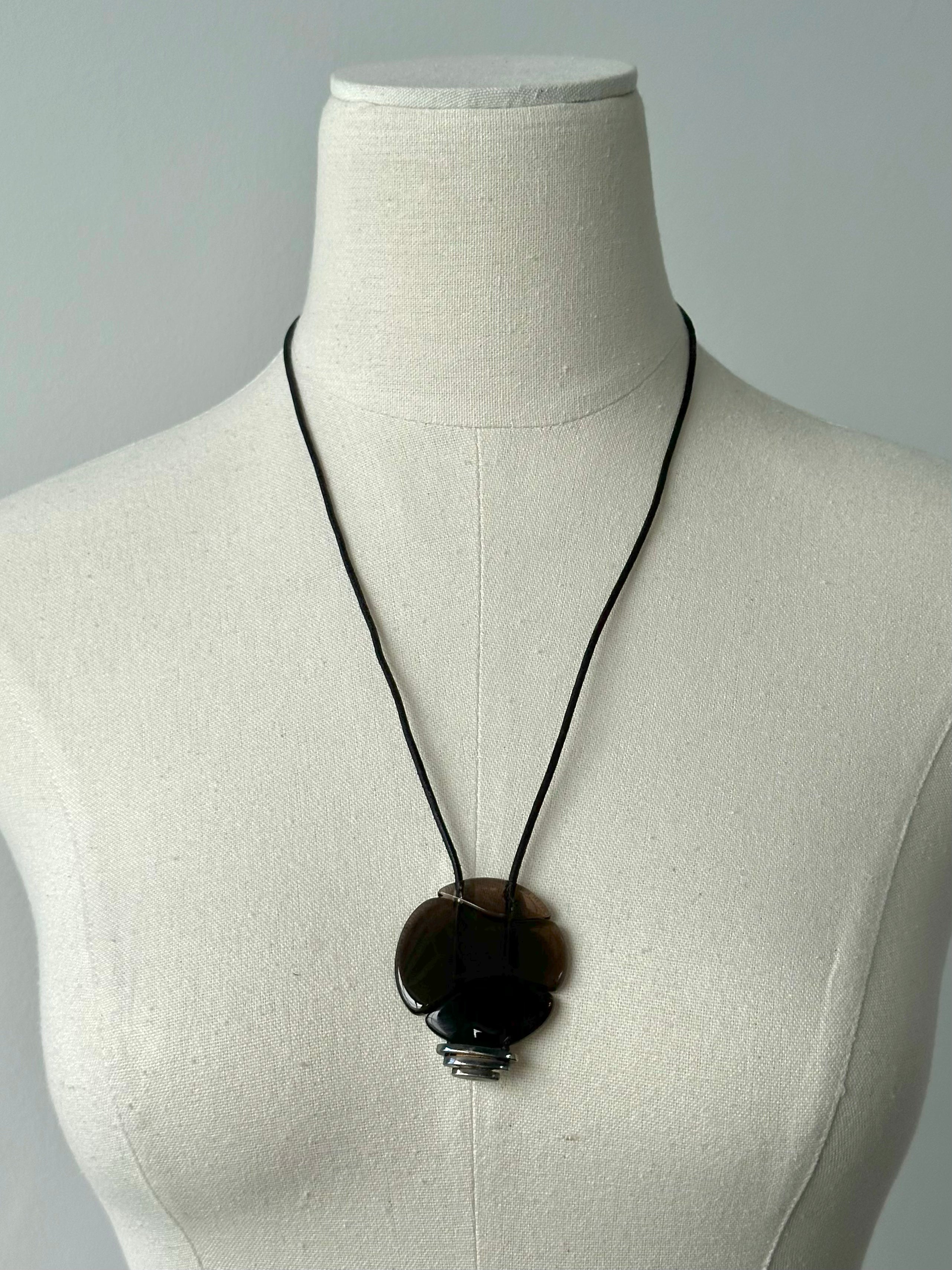 Emporio Armani 2000s glass pendant leather necklace featuring a sleek glass pendant on a leather cord, stylish jewelry accessory.