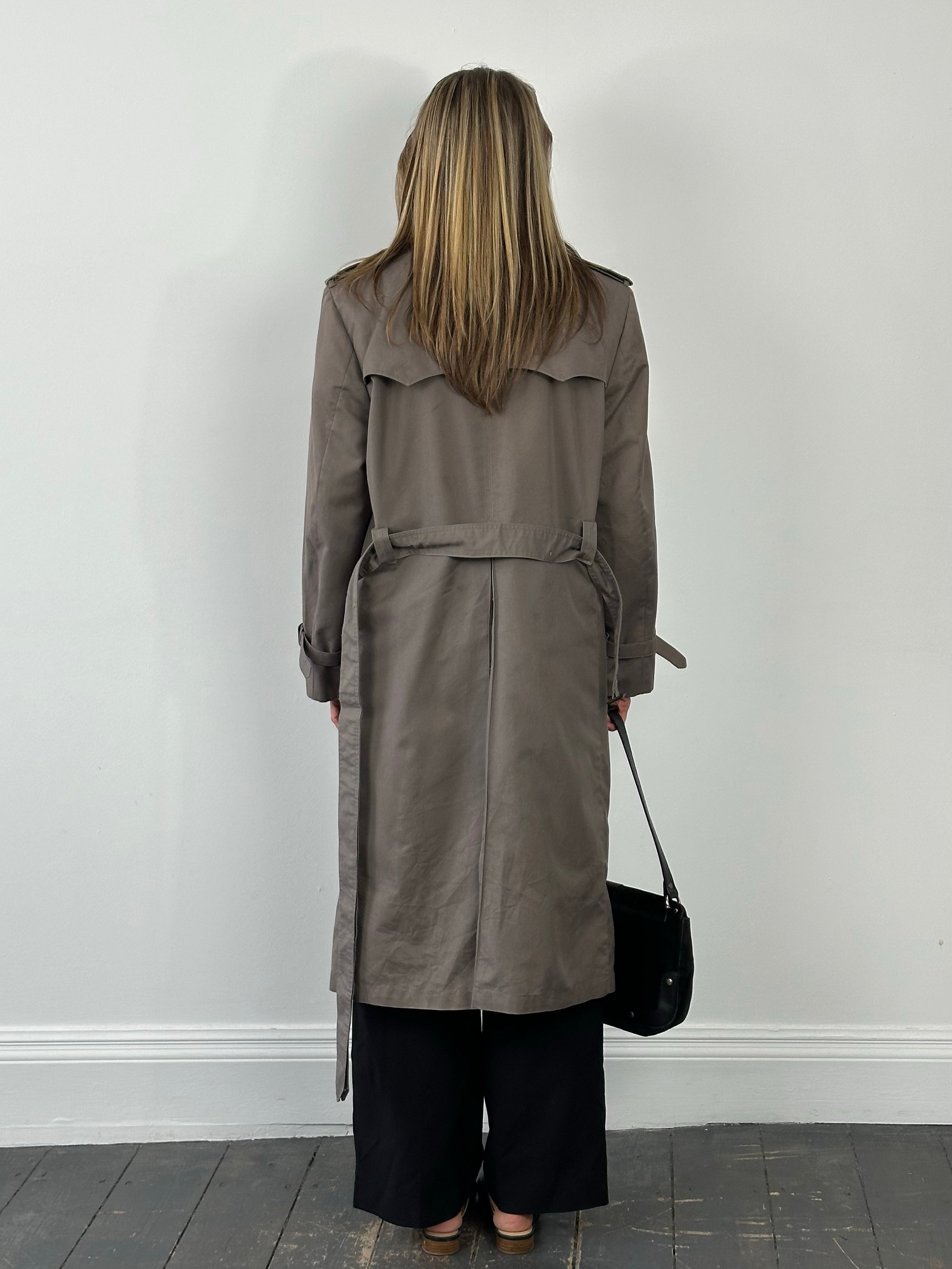 Christian Dior Monsieur 1980s double-breasted belted trench coat showing classic beige fabric and tailored design.