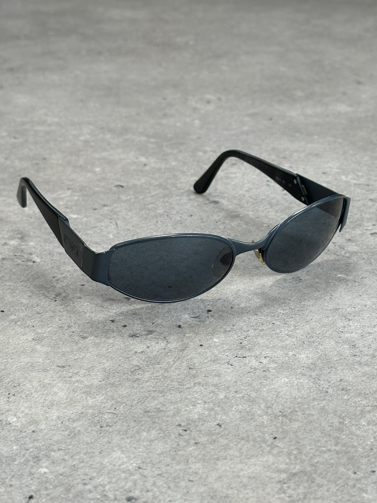 Emporio Armani 1990s oval logo sunglasses with dark tinted lenses and sleek black frame.