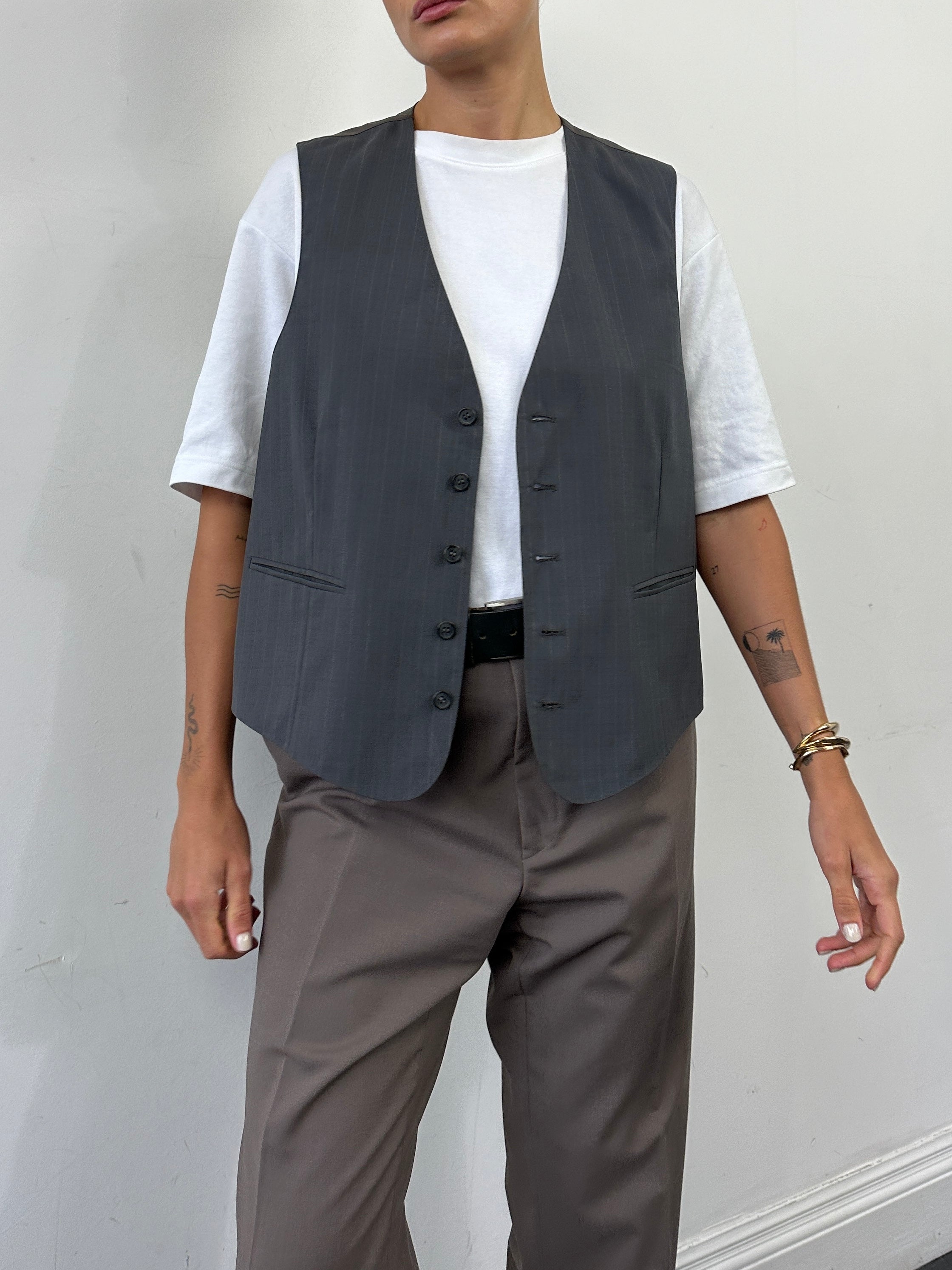Vintage 1990s striped tailored waistcoat in size L, featuring classic design and bold color accents, ideal for retro fashion styles.