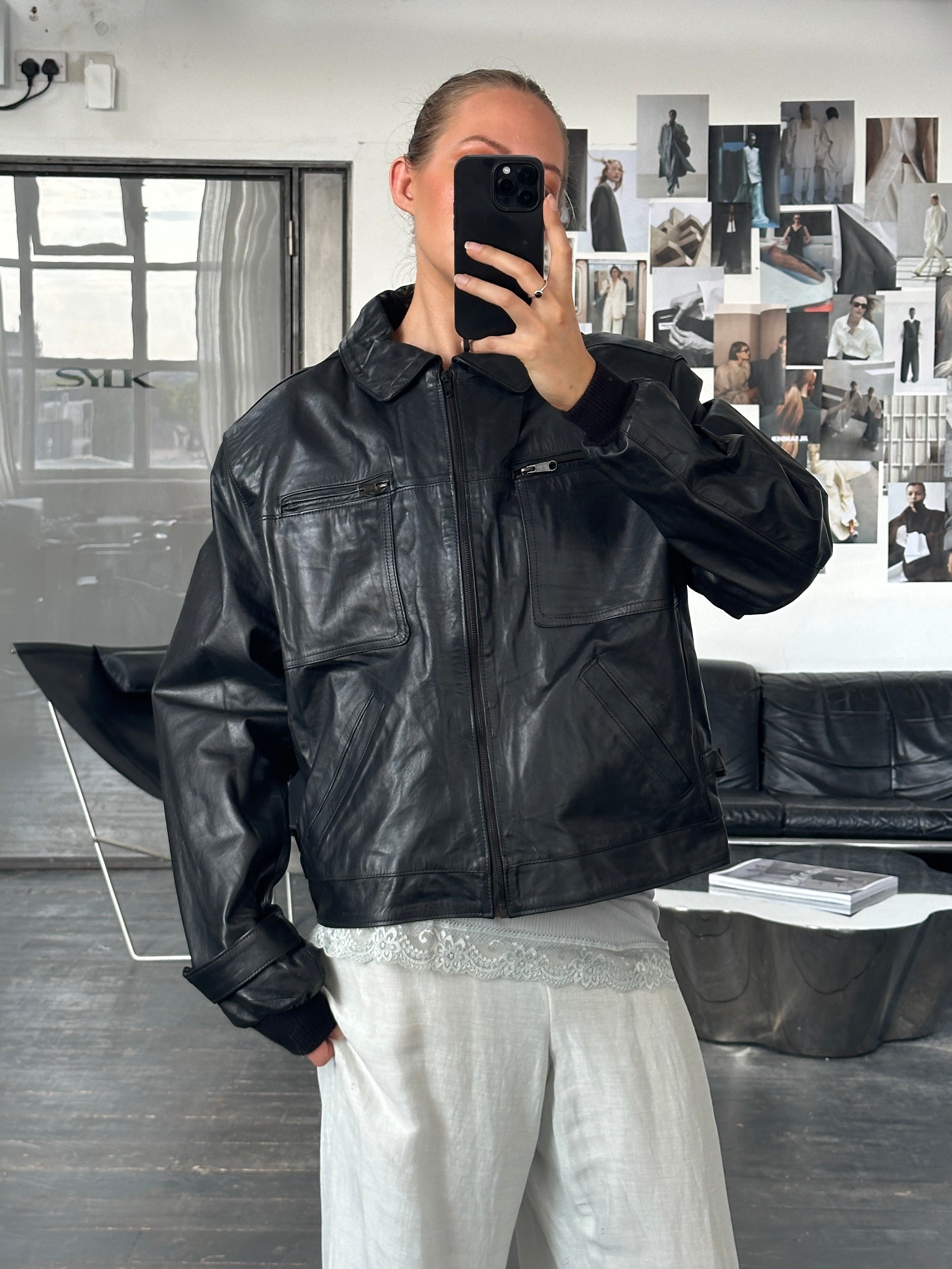 Vintage 1990s boxy cropped leather jacket in black, featuring a classic design and silver zipper details.