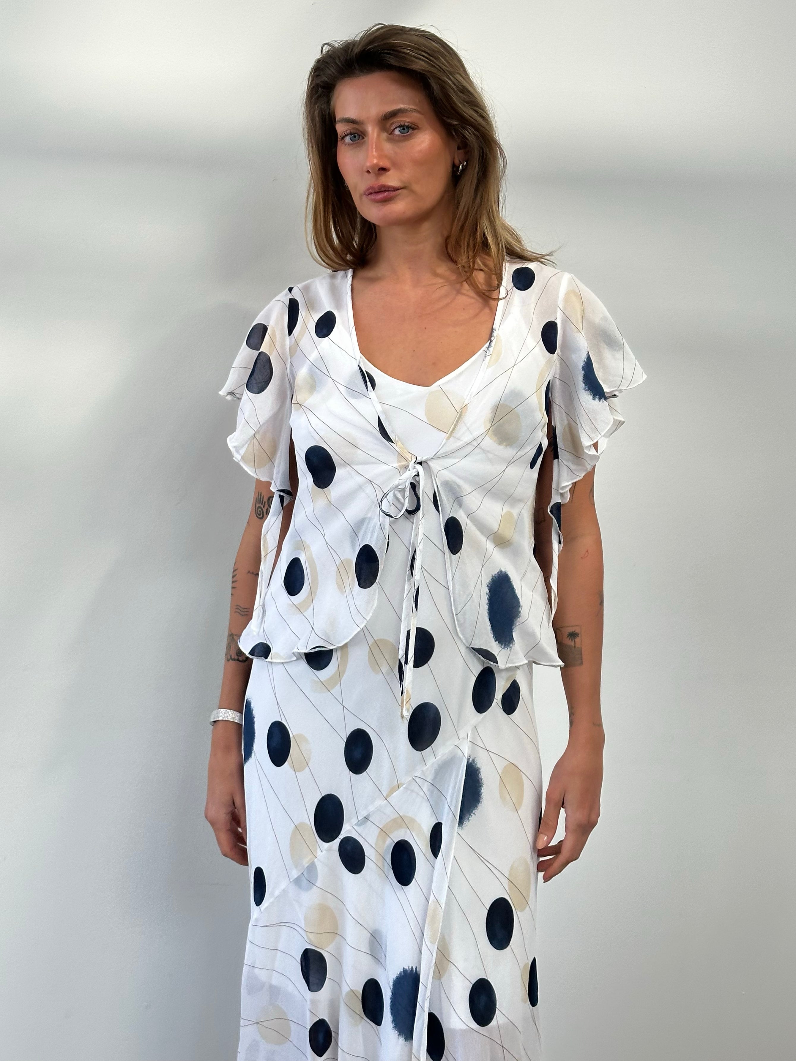 MANI 1990s spotted two-piece slip dress set in black and white, featuring a sleeveless top and matching skirt style.