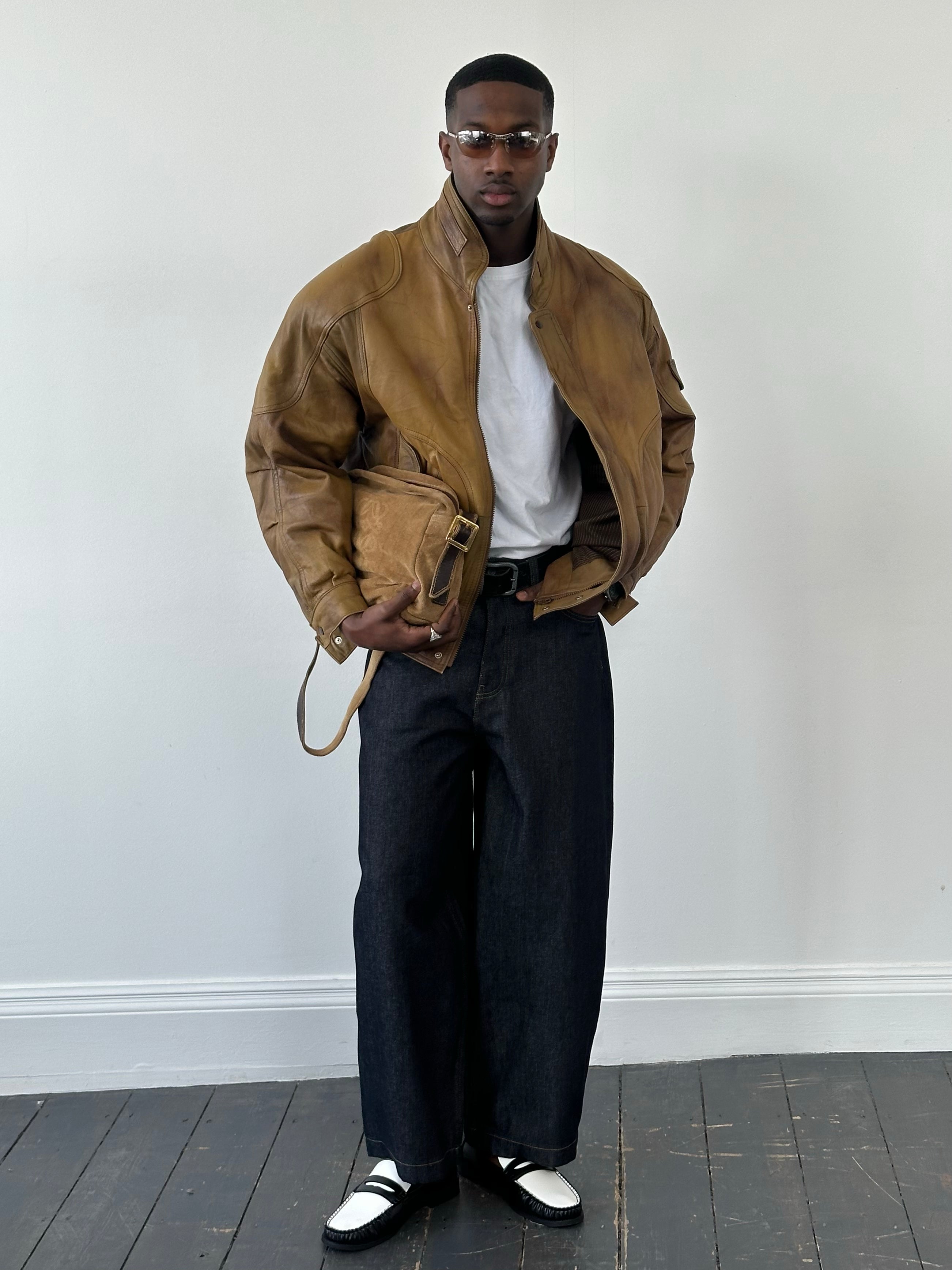 Vintage 1990s leather bomber jacket with high neck, men's size L, featuring classic leather construction and retro style.