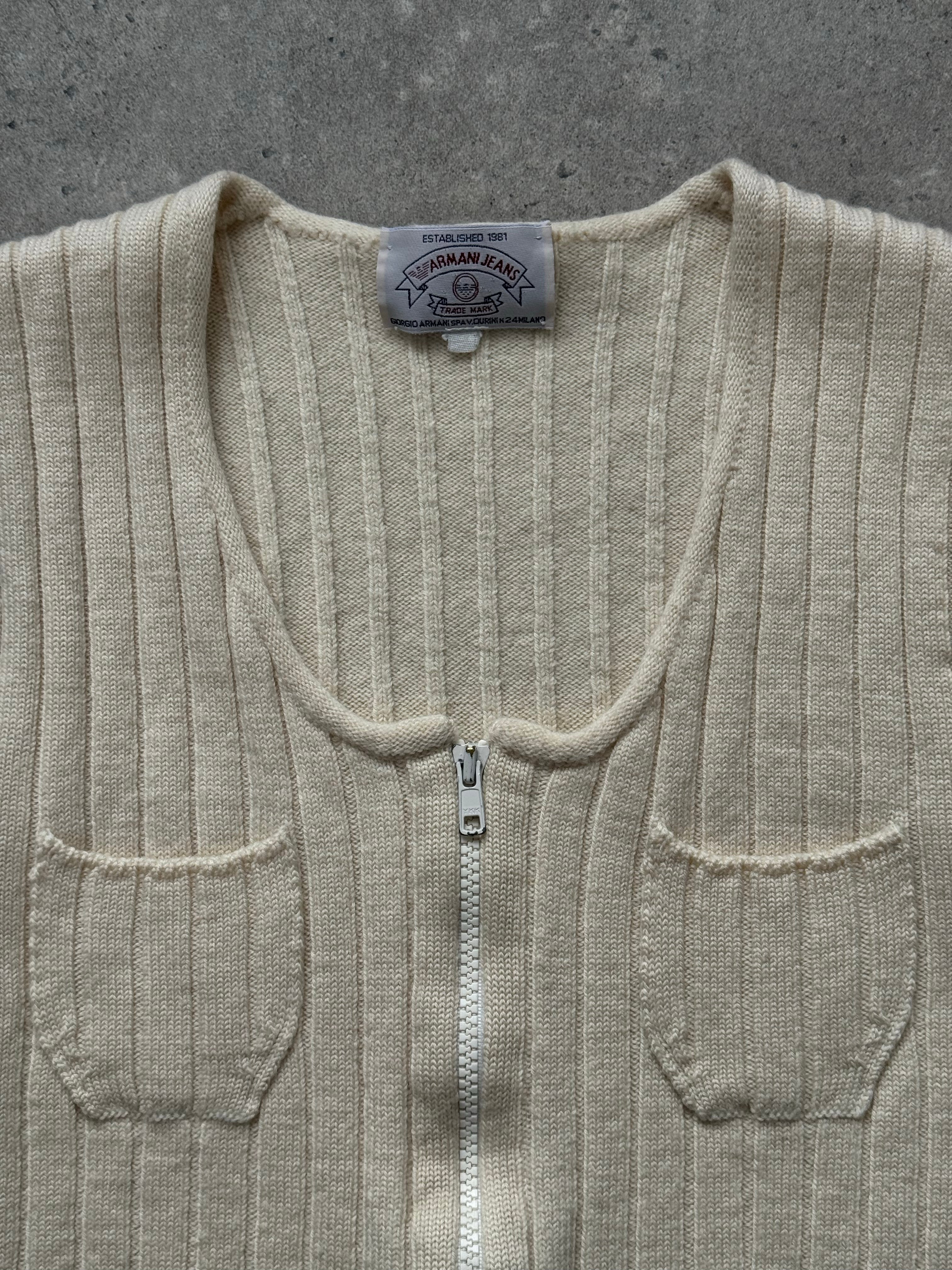 Armani Jeans 1990s pure wool knit top in XS, featuring a classic crewneck and ribbed texture, off-white color, and fitted style.