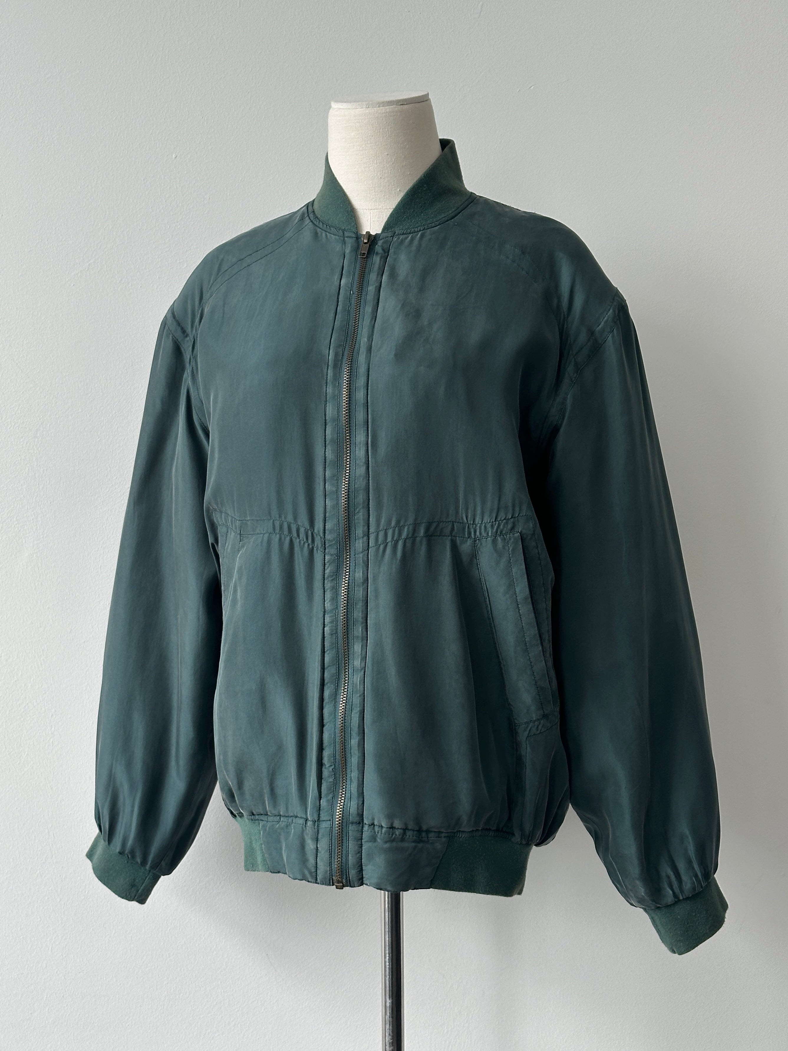 Vintage 1990s pure silk bomber jacket in size M, featuring a classic design with a smooth, shiny silk finish.