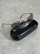 Gucci 2000s rimless sunglasses with clear lenses and thin metal temples, stylish eyewear displayed on a white background.