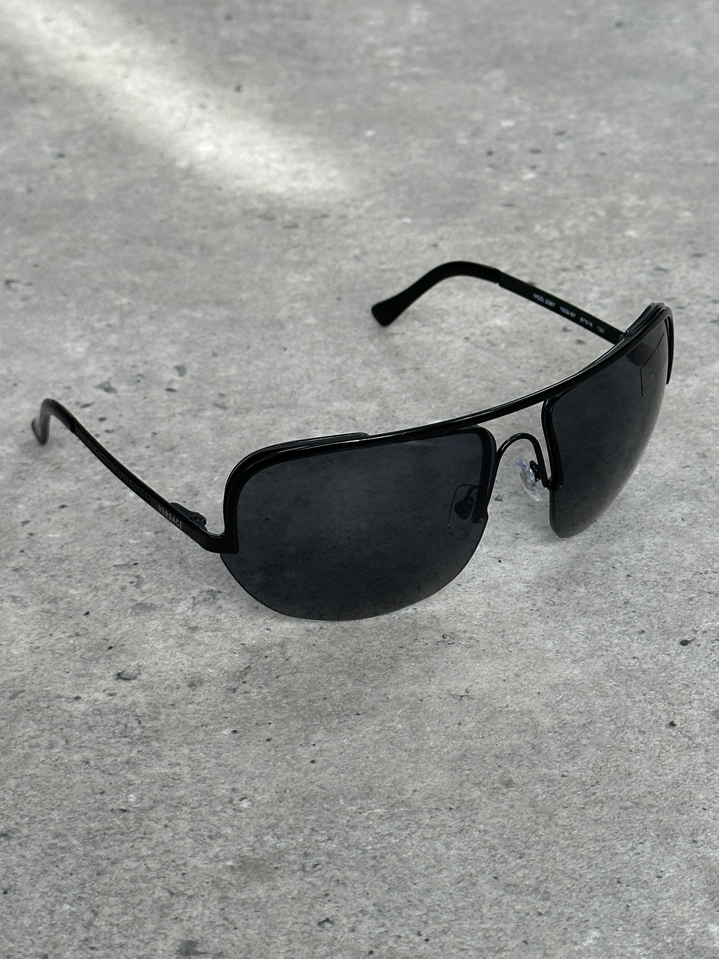 Versace 2000s Shield Aviator Logo Sunglasses with bold black frame and iconic Versace logo on the temples.