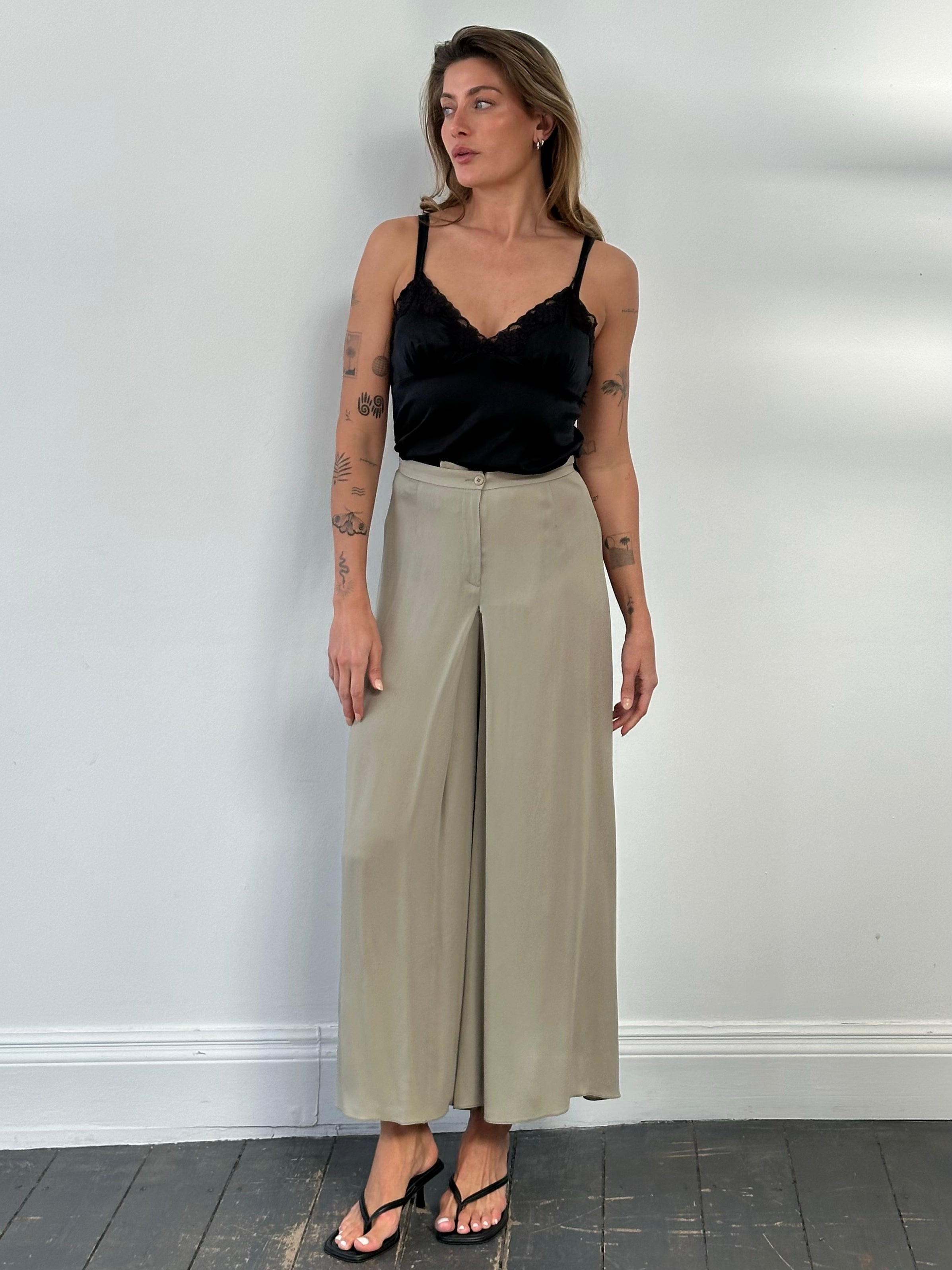Armani Collezioni 2000s silk wide-leg pleated trousers in deep green, with a W26 waist, displayed flat on a white background.