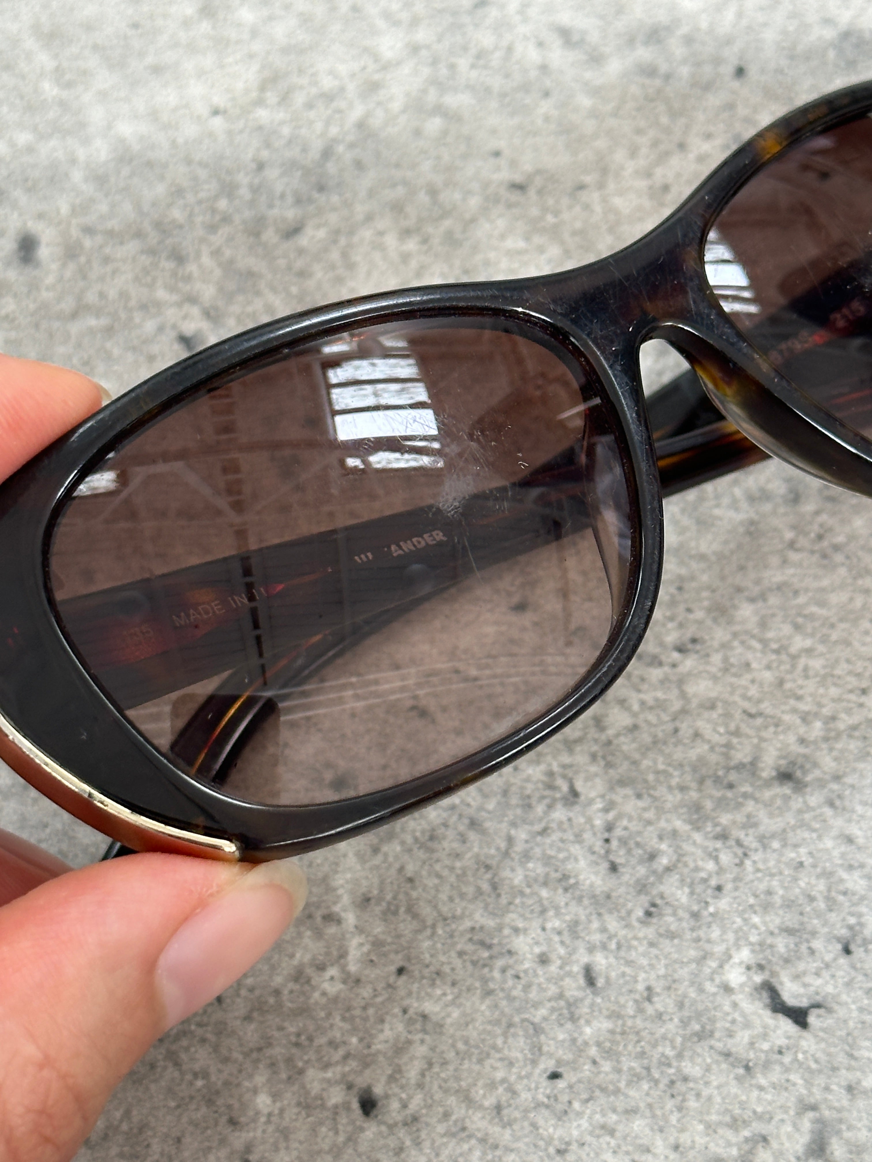 Jil Sander tortoiseshell rectangular logo sunglasses with dark lenses, stylish 2000s design, and brand logo on the temples.