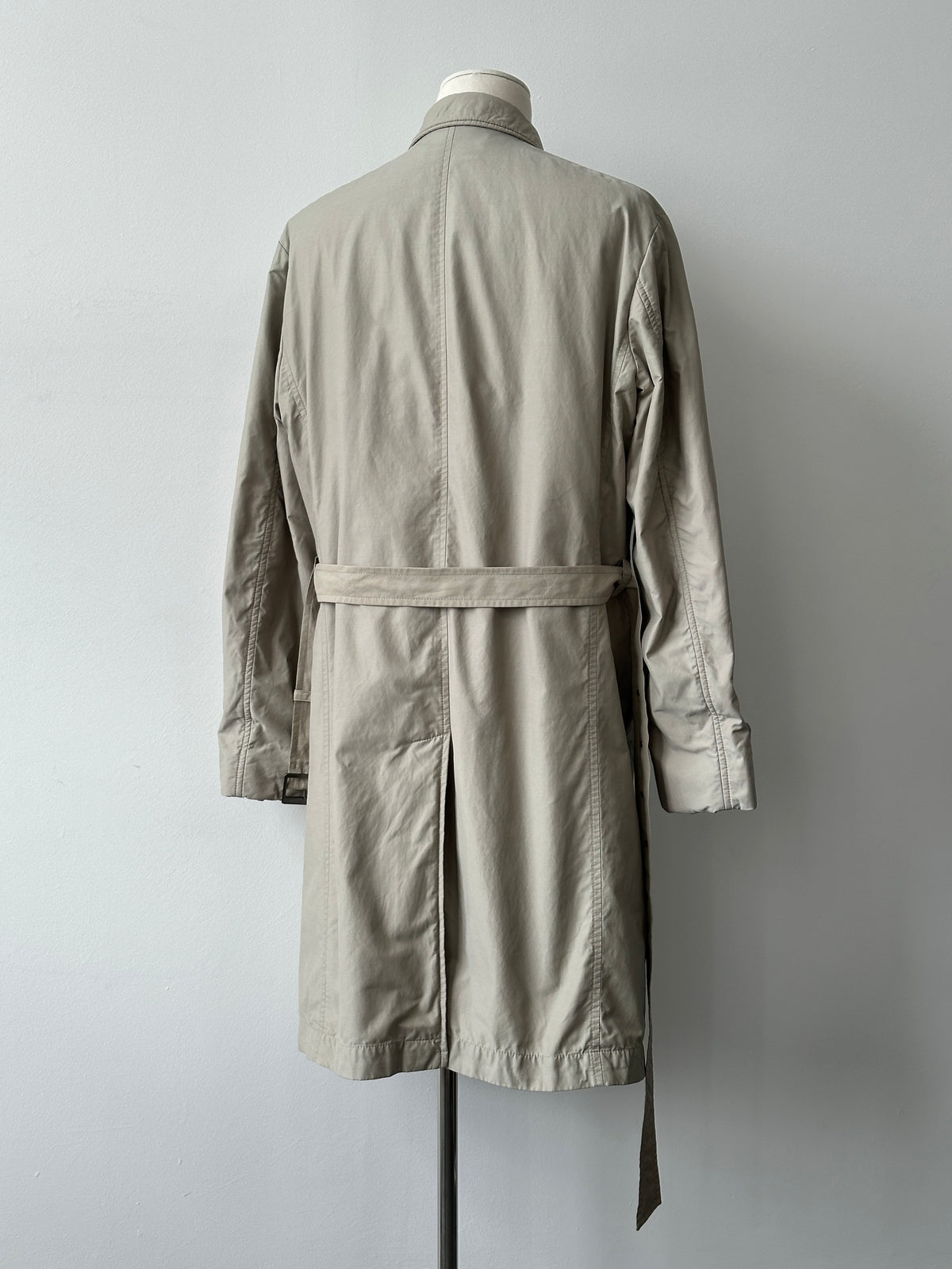 Hugo Boss 2000s high-neck belted trench coat in beige, shown on a model, featuring a classic silhouette and stylish belt detail.