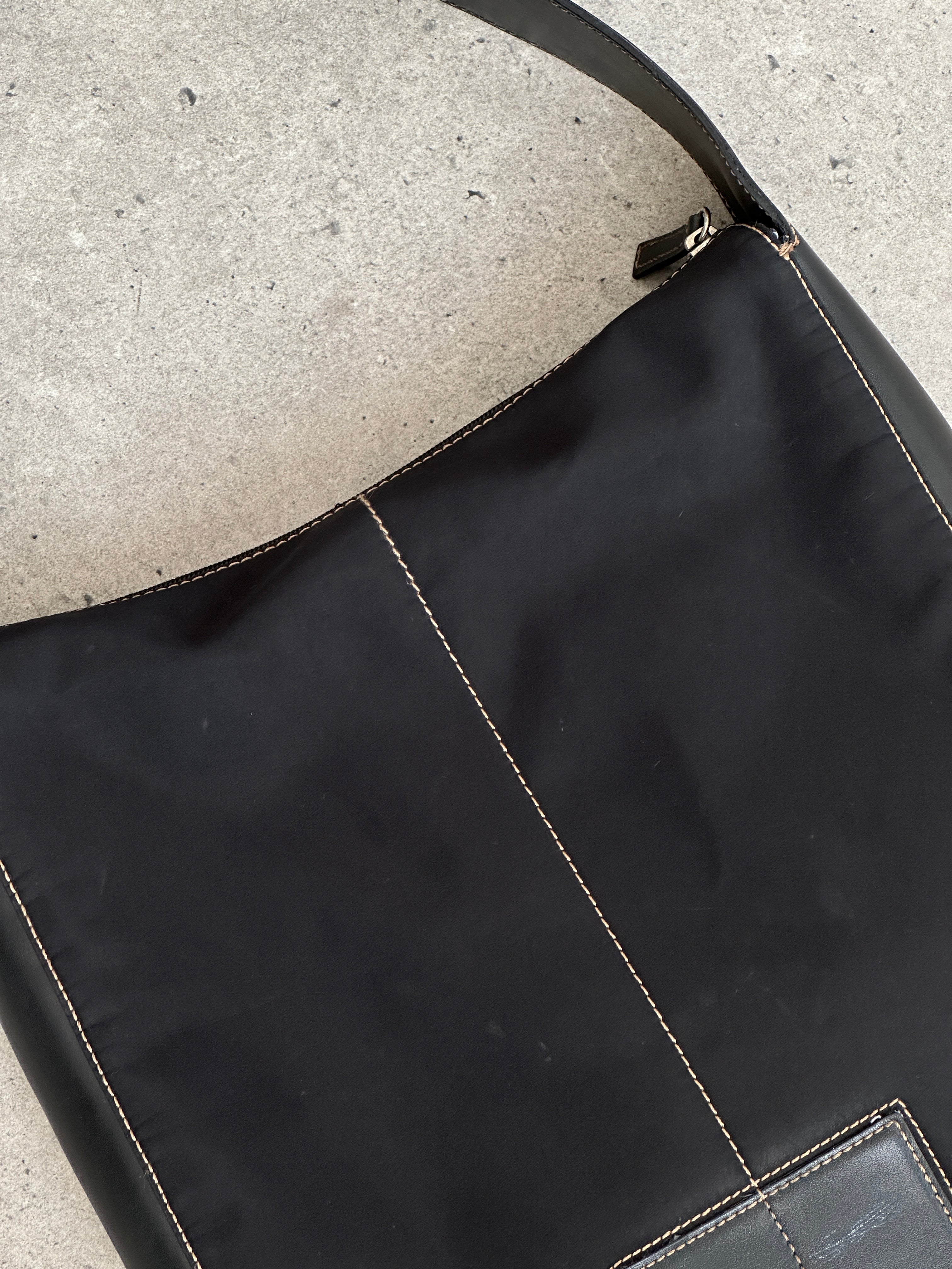 Donna Karan DKNY 2000s contrast stitch shoulder bag with quilted design and sleek black exterior, featuring contrasting white stitching.